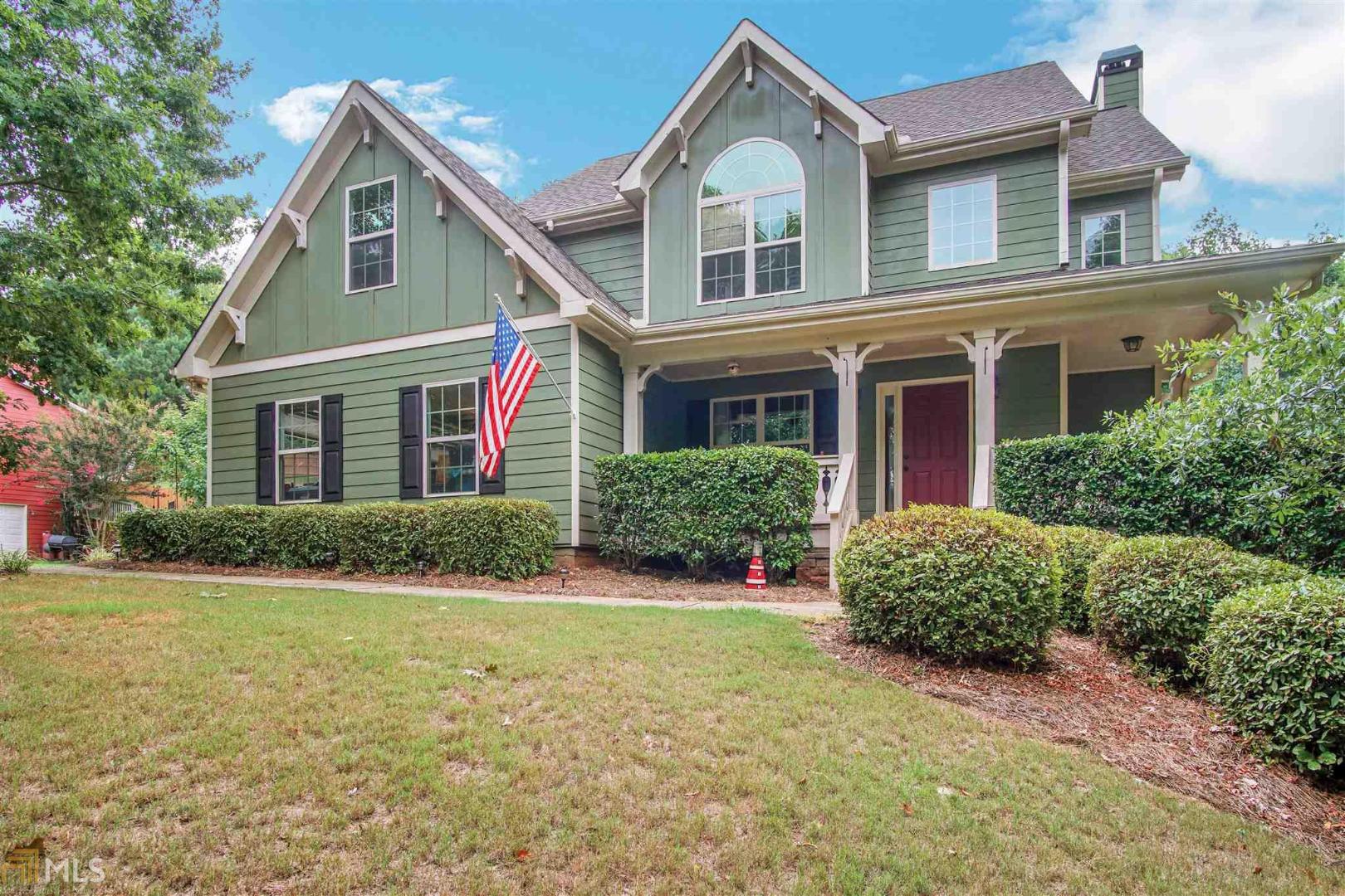 Step up to the rocking chair front porch and into a 2 story foyer. This home offers beautiful hardwood floors. Separate DR with wainscoting. Large kitchen w/ sunny breakfast room open to family room with stone fireplace and built in bookcases. Upstairs has 4 bdrms. One w/ vaulted ceiling and palladian window. Large master has trey ceiling w/ his and hers closets. Bath has separate shower w/ garden tub. Beautiful yard on over 1/2 acre w/ fenced backyard.Roof is 3 yrs old. Lennox HVAC units - 2 yrs old. Neighborhood pool w/ grilling area. Large wooded playground w/ pavilion.