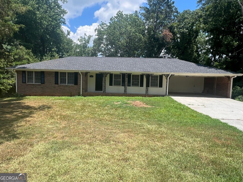 Completely Renovated 3 Bedroom, 2 Bath 4-Sided Brick Ranch with Basement & Private Backyard. This beautifully updated ranch features LVP flooring throughout the main living areas and showcases a spacious family room with a classic brick fireplace. The renovated kitchen includes stainless steel appliances, new cabinets and new countertops and a breakfast area. A formal living room and formal dining room offer flexible living or entertaining space. The oversized master bedroom features two closets and a private updated bath. Two generously sized guest bedrooms share a updated hall bath with a new vanity and tiled tub/shower. Additional highlights include a mudroom, full unfinished basement ready for future expansion, architectural roof, deck, rocking chair front porch, carport, and private backyard. Move-in ready and conveniently located near shopping, dining, and major highways.