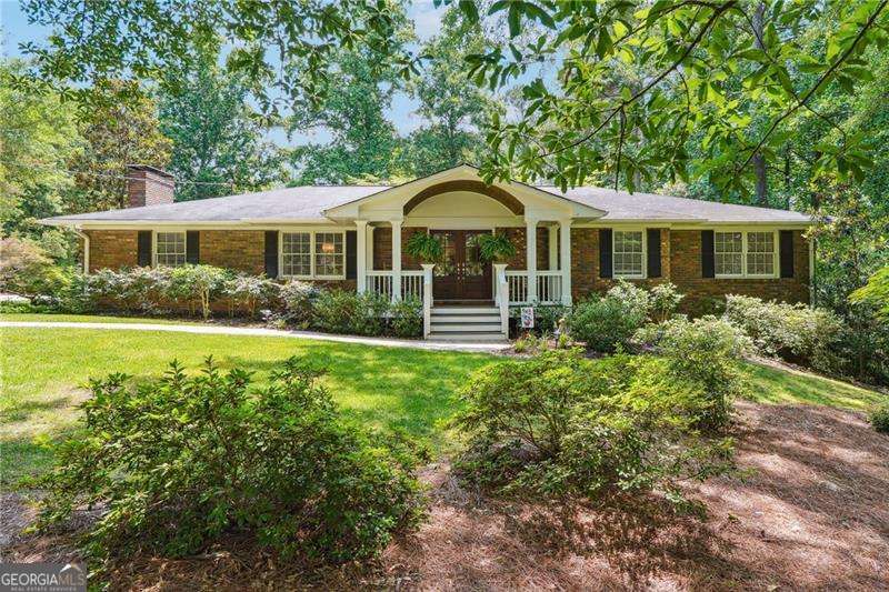Don't miss this updated ranch on almost an acre in East Cobb!! Hardwood floors greet you as you enter into the large foyer, separate dining room with gourmet kitchen with quartz c/ tops and white cabinets. Kitchen features s/steel appliances with wine cooler and pot filler over the gas cooktop. Large island great for entertaining and open to the family room. Family room w/fireplace and entry out to the screened in porch. Over sized master with master bath that offers jetted tub, double vanities and separate shower. Spacious bedrooms with hall bath on main level. One of the bedrooms now serves as a huge his and hers closet that can easily be put back to a bedroom. Basement finished and offers large man cave area with custom wet bar with refrigerator and microwave. The basement also has a fireplace. Two large bedrooms downstairs with full bath. Laundry room downstairs. Storage area downstairs. Yard is a gardeners paradise. professionally landscaped with irrigation system front and back. Brick patio with built in bench and firepit. Hot tub with private pergola. Fenced in backyard. Detached garage with electrical outlet to accommodate RV or trailer. This house suites alot of needs for everyone!! Someone who wants location, one level living with privacy or someone who is a car enthusiast. Close to shopping , schools and Truist park!!