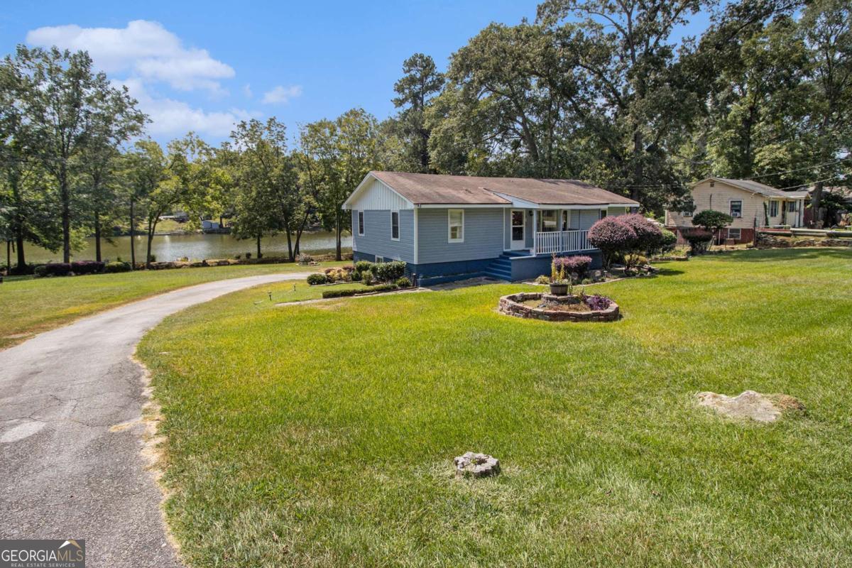 Unique property on large lot with beautiful lake view! This home has lots of updates including new paint and an upgraded kitchen with granite and large island. You'll love the sunroom with tons of natural light and lake views. Large primary bedroom. The basement has a screened porch and an additional bedroom and bathroom. 1 car garage. Lots of storage. The lot is the largest in the neighborhood and features over 200 feet of lakeshore. Don't miss your chance on this one!