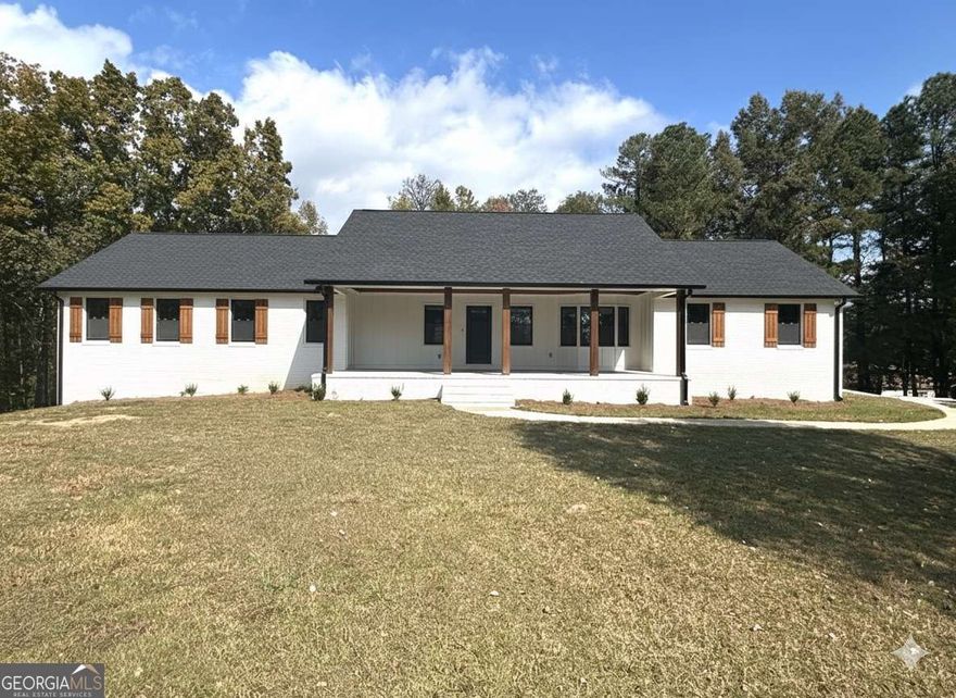 RENOVATED RANCH RETREAT on 2 Private Acres with Outdoor Fireplace!  Experience the perfect blend of modern luxury and serene country living. This stunning, fully renovated 3-bed, 2-bath ranch sits on a sprawling 2-acre private lot, providing the peace you crave while remaining minutes from schools and shopping.  The chef's kitchen is a showpiece, boasting elegant quartz countertops and upgraded white cabinets, opening seamlessly to a floor plan designed for effortless entertaining. Cozy up on the large covered front porch with beautiful wood accents or host unforgettable evenings on the covered back deck featuring a magnificent fireplace.  The primary suite is your private oasis, complete with a spa-like bath featuring a garden soaking tub, separate walk-in tiled shower, and double vanities. Inside, enjoy the low-maintenance beauty of luxury vinyl plank flooring throughout-absolutely no carpet! Need more space? The huge finished basement room is ready to be your rec room, home gym, or ultimate "man cave."    Don't miss this rare opportunity for acreage and high-end upgrades!