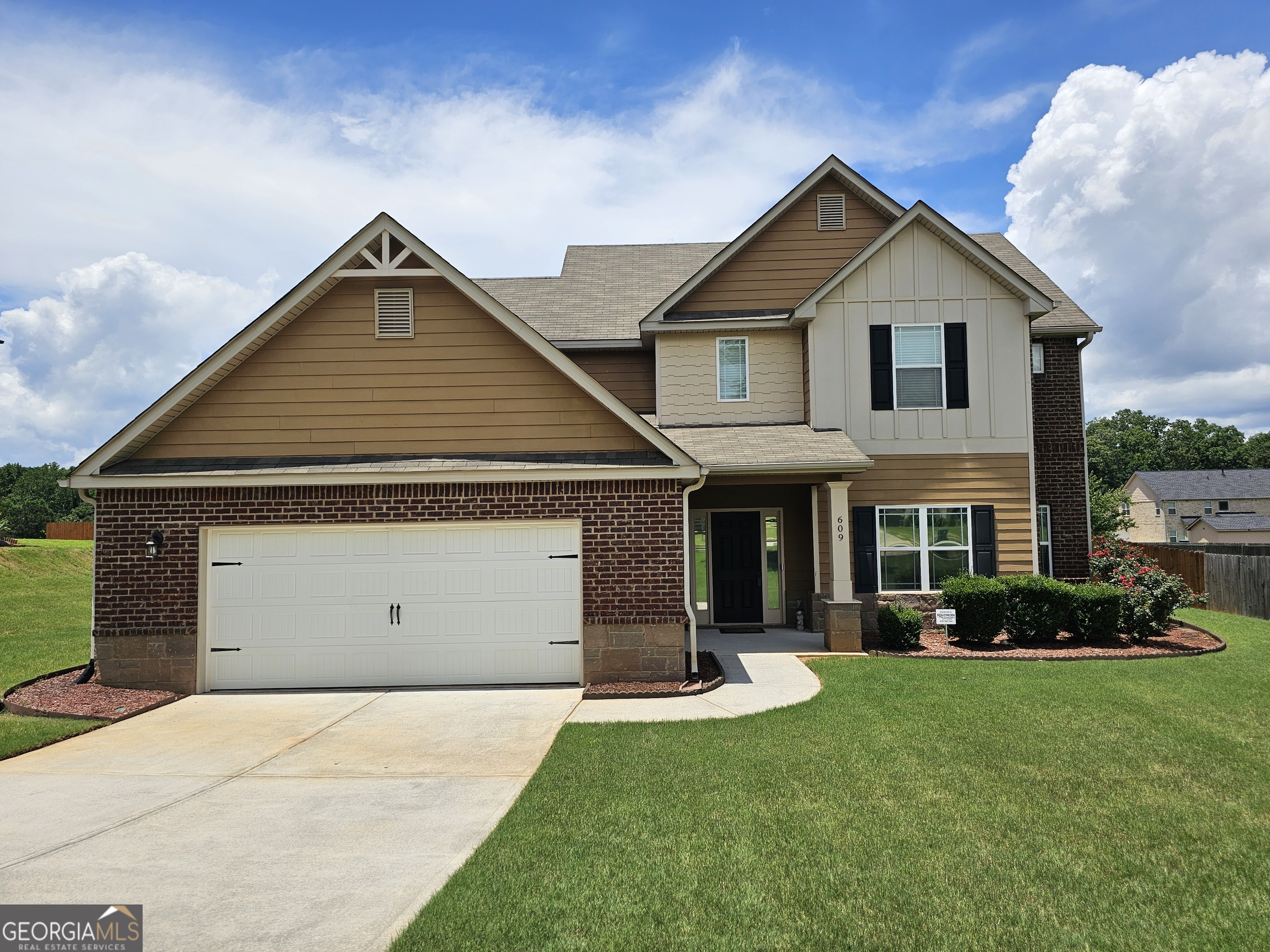 Welcome to this stunning 3 sides brick craftsman style home which offers an oversized primary suite on the main. A grand two-story family room creates the perfect setting for gatherings and memory making. Upstairs, you'll find three generously sized bedrooms, a loft area and two full baths with plenty of room for family or guests. All bedrooms have direct access to a full bath. At the heart of the home, a thoughtfully designed open kitchen features a coveted double oven perfect for cooking, baking, and entertaining with ease. Offering ample counter space and storage. Step outside to enjoy a large, fully fenced backyard safe and spacious for kids and pets. The screened-in rear porch offers a peaceful retreat for morning coffee or evening unwinding. Families love the easily walkable sidewalks dedicated throughout this beautiful community. Located in walking distance to Ola High, Middle and Elementary schools. Don't miss the chance to make this inviting family haven your forever home!