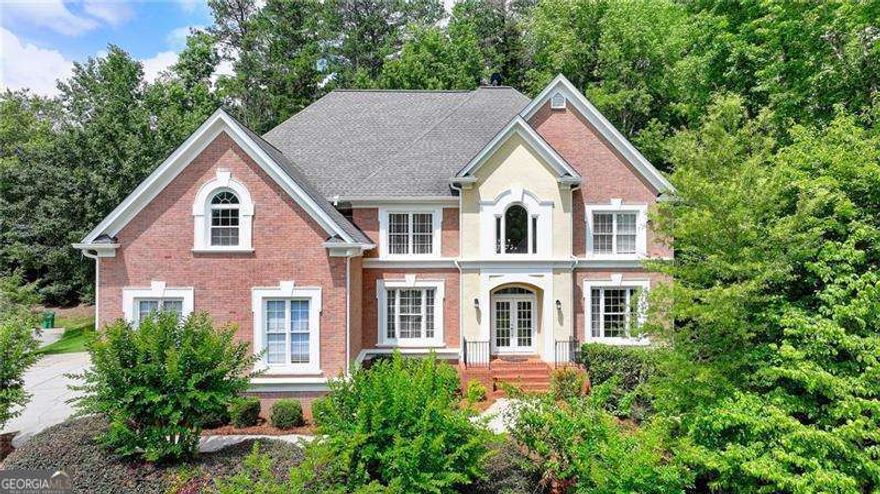 Highly Desirable Home in Seven Oaks Subdivision - Prestigious Johns Creek Location - Northview High School District!! Welcome to this stunning 6-bedroom, 5.5-bathroom home nestled in the sought-after Seven Oaks community, located in the heart of Johns Creek and zoned for the award-winning Northview High School. Situated on a beautifully landscaped, private, wooded cul-de-sac lot, this spacious, light-filled home offers exceptional curb appeal and tremendous potential. Step into the grand two-story foyer leading to the formal living and dining rooms. The bright white kitchen features a breakfast bar and flows seamlessly into the dramatic two-story family room-perfect for entertaining. A large deck overlooks the wooded backyard, offering a peaceful setting for relaxation or gatherings. The main level includes a laundry room, half bath, a guest bedroom or office, and a full bath. Upstairs, the oversized owner's suite boasts a tray ceiling, fireplace, walk-in closets for Her and Him and a spa-inspired bath. Additional upstairs bedrooms include one with a private bath and two sharing a convenient Jack-and-Jill bathroom. Other notable features include hardwood floors, plantation shutters, front and rear staircases, and a spacious 3-car side-entry garage. The fully finished basement level offers exceptional versatility, complete with a wet bar, mini kitchenette, media room, and entertainment spaces-ideal for hosting guests or creating an in-law suite. Seven Oaks is one of North Fulton's premier active communities, featuring resort-style amenities: an Olympic-size swimming pool, kiddie pool, 8 lighted tennis courts, pickleball courts, clubhouse, fitness center, soccer field, community lake, scenic walking trails, and a charming gazebo area used year-round for community events, graduations, wedding photos, and concerts. Enjoy the convenience of being just minutes from top-tier shopping and dining at Halcyon and Avalon, and close to Johns Creek Emory Hospital. Recent updates include freshly refinished hardwood floors on the main level, updated light and ceiling fan fixtures on two levels, and fresh paint in many areas, including the garage. Don't miss the opportunity to own this exceptional home in one of Johns Creek's most coveted neighborhoods!