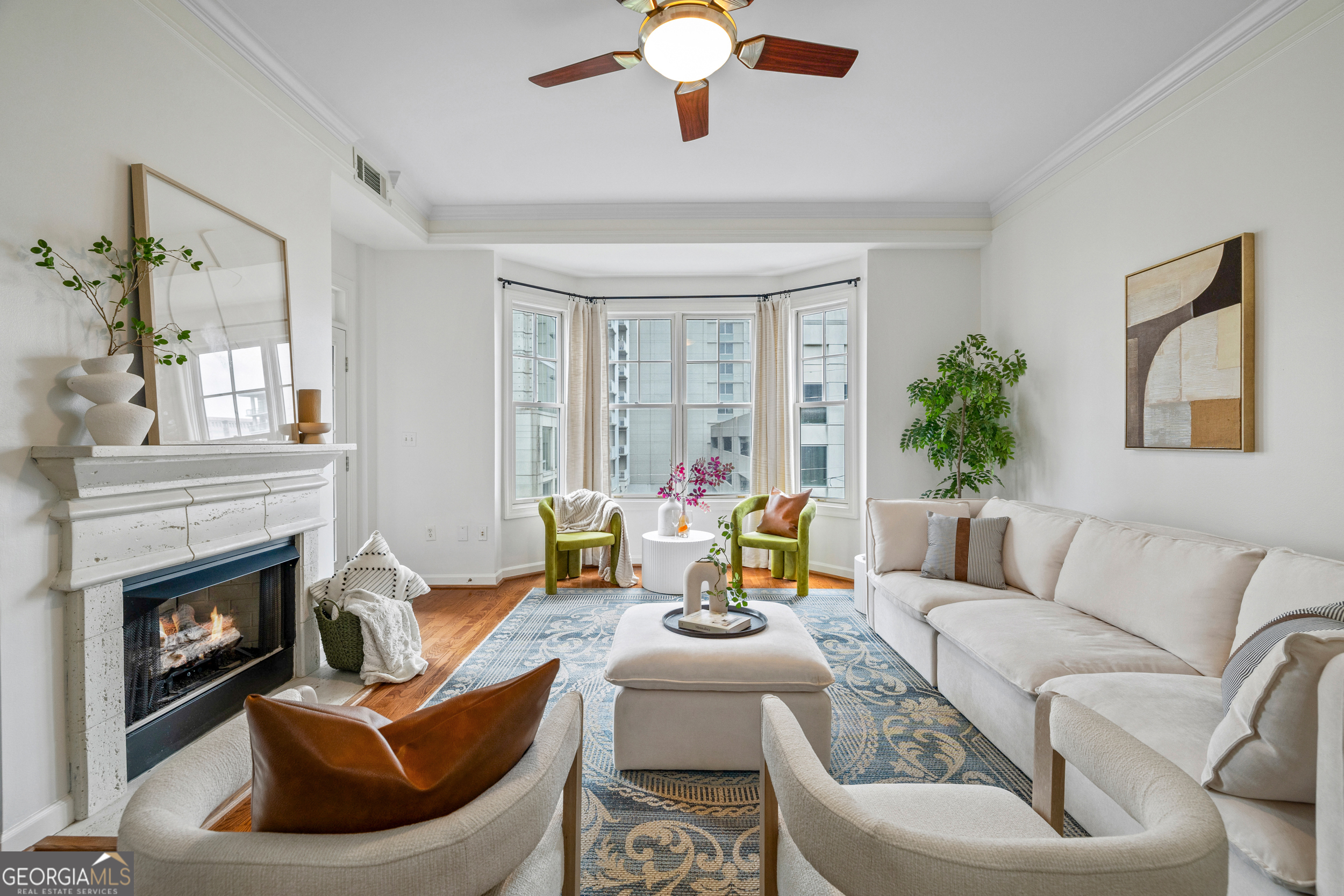 Impressive 970 sq ft condo offering one of Midtown's largest 1-bedroom layouts. Open living and dining area with hardwood floors, fresh paint, and cozy fireplace. Kitchen features granite countertops, stainless steel appliances, and ample storage. Spacious bedroom with walk-in closet and ensuite bath with soaking tub and separate shower. Juliet balcony overlooks Midtown's vibrant streetscape. Unite includes two deeded garage spaces. The Dakota offers a rooftop pool, fitness center, and landscaped courtyards in a secure, pet-friendly community. Prime location between Juniper and Piedmont, steps from Piedmont Park, the Beltline, Fox Theatre, and top dining and shopping. Move-in ready and beautifully maintained!