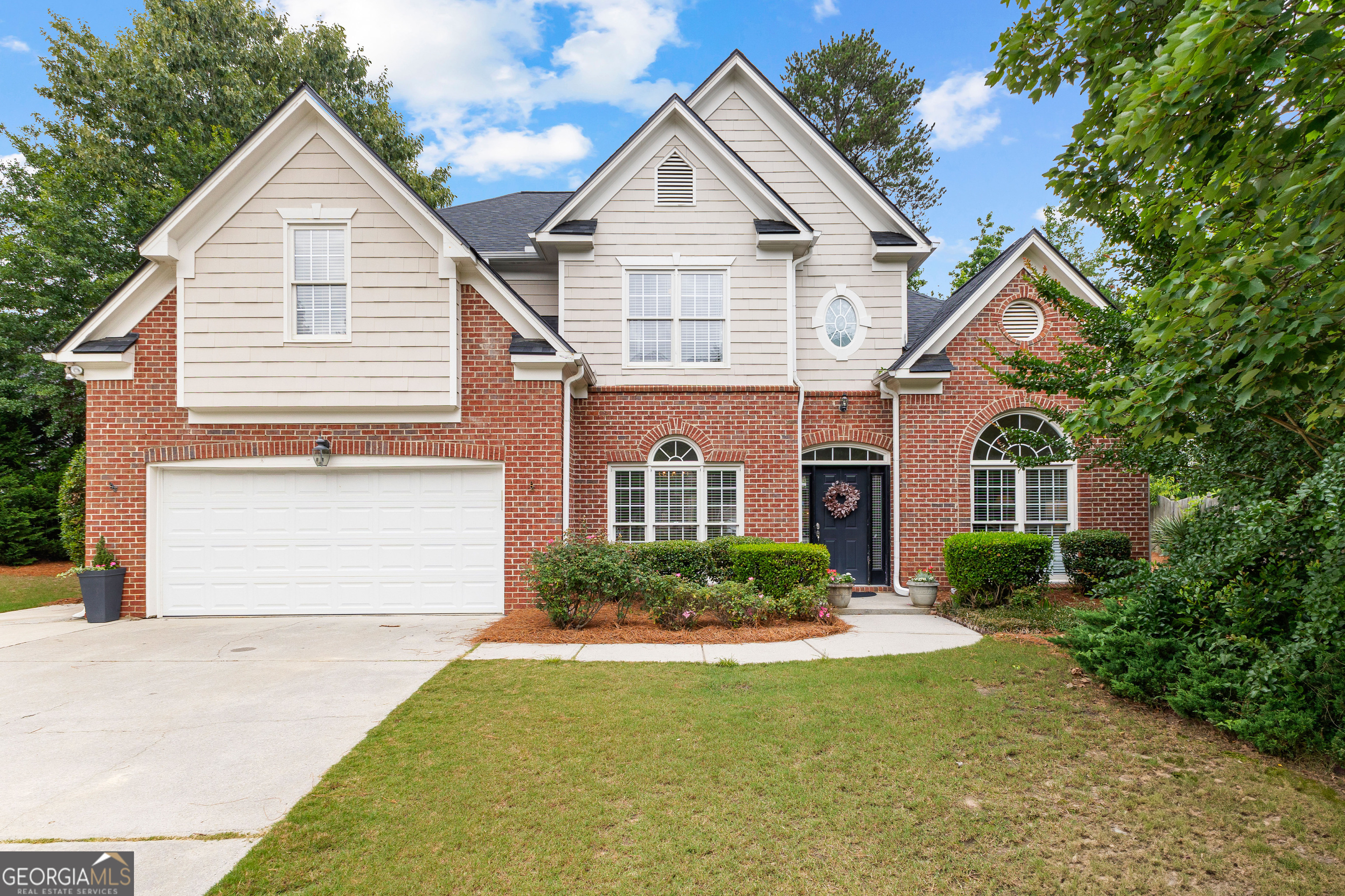 Gorgeous Home in the Sought-After Starr's Mill School District! This stunning, impeccably maintained home is the epitome of perfection, ideally located in a quiet cul-de-sac. From the moment you step inside, you will be captivated by the light-filled, airy feel and thoughtful updates throughout. The inviting two-story family room features a striking stone fireplace and flows seamlessly into the beautifully updated kitchen. The kitchen boasts new white cabinetry with soft close hinges, a spacious breakfast area, and a charming bay window that floods the space with natural light-perfect for everyday living and entertaining alike. On the main floor, you will find a secondary bedroom and full bath-ideal for guests or a convenient home office. Upstairs, the oversized primary suite offers a peaceful retreat with tray ceilings, a spa-like ensuite bath featuring double vanities, a separate tiled shower and soaking tub, and a large walk-in closet. Two additional bedrooms and two full bathrooms complete the upper level. This picture-perfect home has it all-updates, charm, space, and location. Do not miss your opportunity to make it yours. Homes like this in the Starr's Mill district do not last long! ***Roof 2017, Cedar Fence 2017, HVACs 2019, Hot Water Heater 2021, New Carpet 2022***
