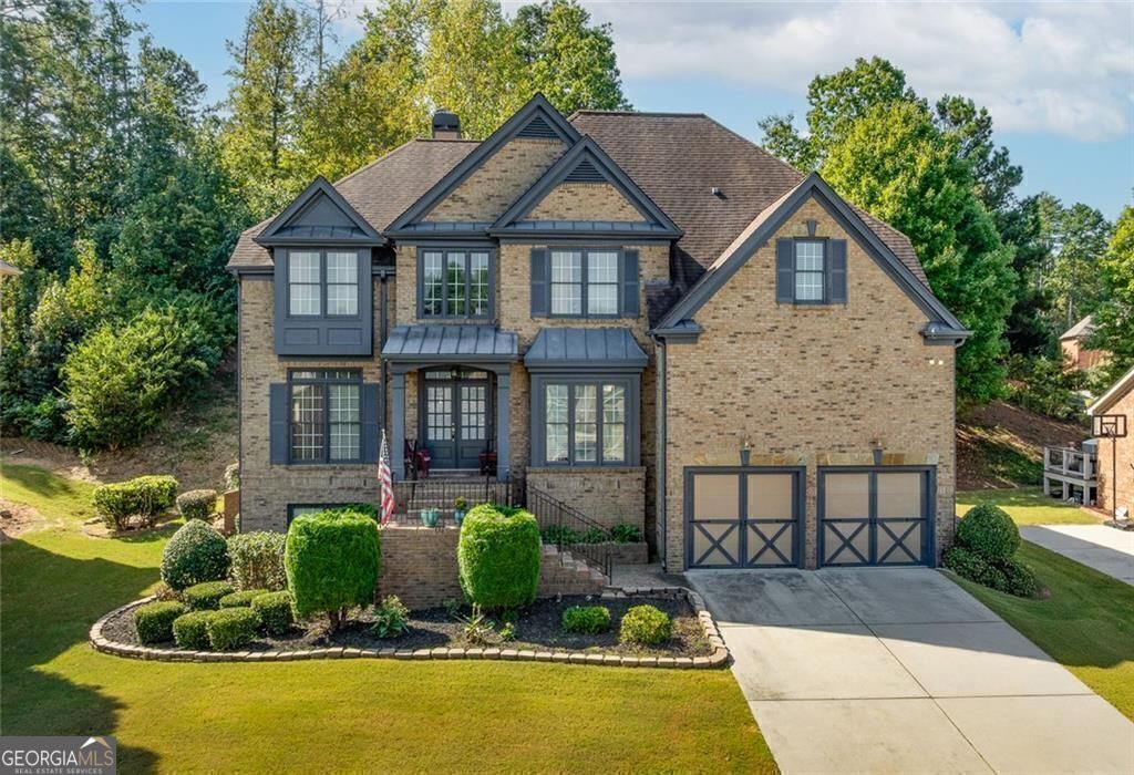 Welcome to this stunning five-bedroom, four-bathroom residence in the highly sought-after Ashley Walk gated community of Suwanee. Situated within the top-rated North Gwinnett High School cluster, this home showcases an open floor plan filled with natural light, spacious living areas, and plenty of room for the entire family. The finished basement offers endless possibilities-featuring a small kitchen, an additional bedroom, and a versatile bonus space ideal for entertaining or relaxation. Conveniently located near multiple parks, the property also invites you to enjoy outdoor living on the screened-in porch and deck, along with access to the community pool.
