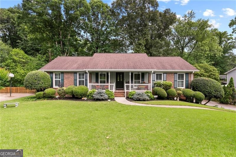 621 Windgrove is a warm home offering the perfect blend of character and convenience. When you arrive you will fall in love with the manicured yard, curb appeal, and the welcoming front porch, a perfect place to have your morning coffee or evening chats. This meticulously maintained large 4-bedroom, 3.5-bath home is filled with timeless charm and thoughtful updates, including NEW HOT WATER HEATER, NEWER HVAC, NEWER WINDOWS, a NEWER ROOF, granite kitchen countertops, and gleaming hardwood floors throughout the main level of the home. The inviting layout offers a comfortable living space for families of all sizes, with a fire side family room, a formal sitting room, and a light-filled kitchen that opens into a spacious dining area. The main level features a PRIMARY BEDROOM ON MAIN with an ensuite bathroom, two additional bedrooms that share a jack and jill bathroom, a 4th bedroom, and a hallway full bathroom. The large finished basement offers a potential 5th bedroom, half bath, laundry, and bonus flex spaces that are ideal for a home office, gym, media room, or play room. There is also an unfinished space perfect for storage. An OVERSIZED 2-CAR GARAGE rounds out the lower level. Outside, the expansive back deck overlooks a peaceful backyard - perfect for entertaining your friends and family or relaxing in privacy. Nestled on a quiet street in one of East Cobb's most desirable locations just a short walk to the neighborhood pool and tennis courts (should you join the optional HOA). Living here you are within close proximity to the energy of The Battery and Braves Stadium, great shops and restaurants, and have easy access to major highways. For those that like getting outdoors, Terrell Mill Park, Sope Creek Paper Mill Ruins, and the Chattahoochee River are just minutes away. This home is tucked within a friendly, well-established neighborhood with an optional HOA with no restrictions. With a fantastic layout and unbeatable location, this home serves up charm, space and flexibility in all the right ways. MOTIVATED SELLER! BRING US AN OFFER!!
