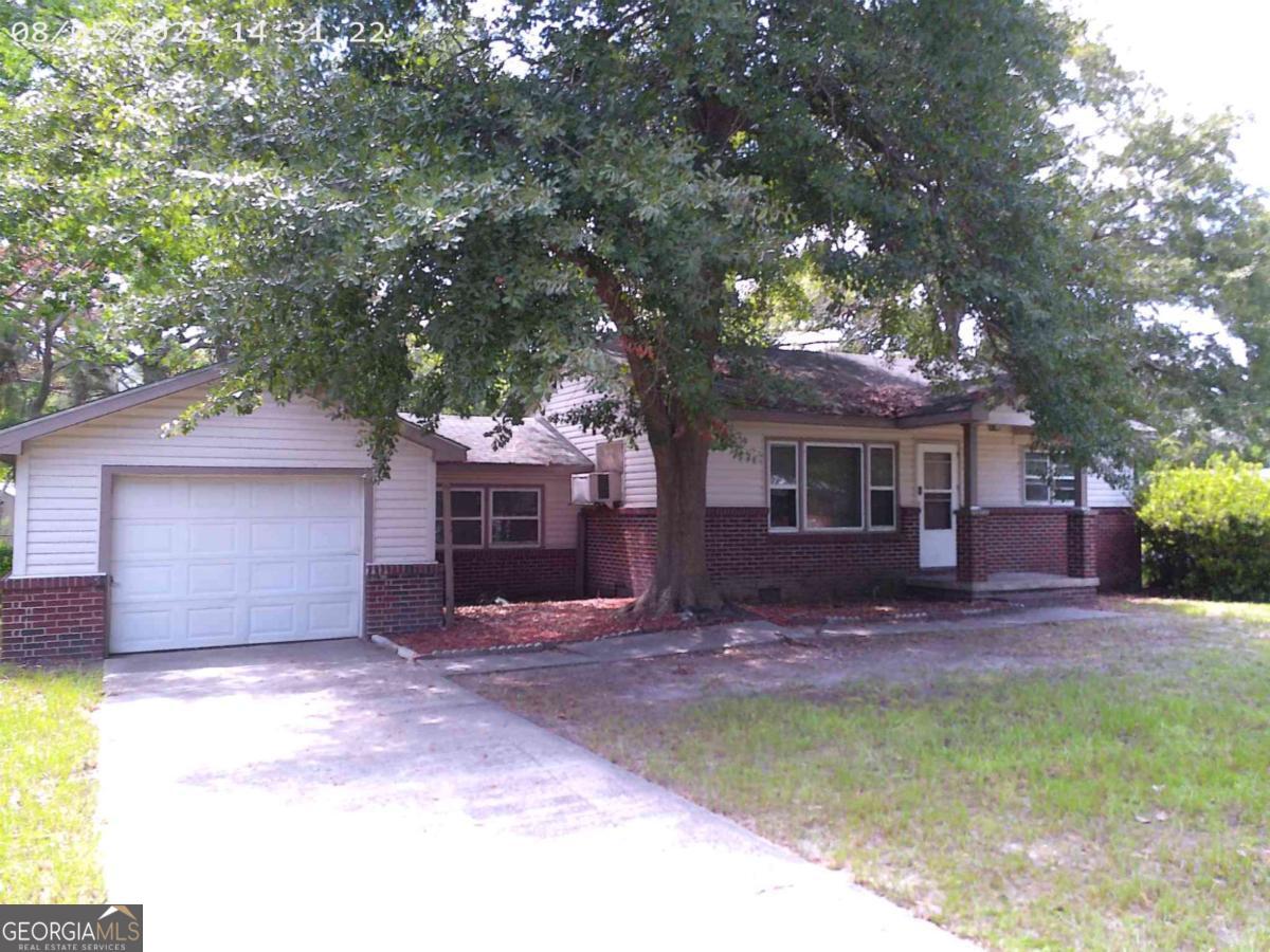 Investor special with so much potential! This cute property w/ additional lot behind the house is centrally located and close to shopping, dining and main gate of Ft Stewart. A large living area open to kitchen and dining offers many possibilities. Being sold AS-IS and needing some TLC. Go check it out!