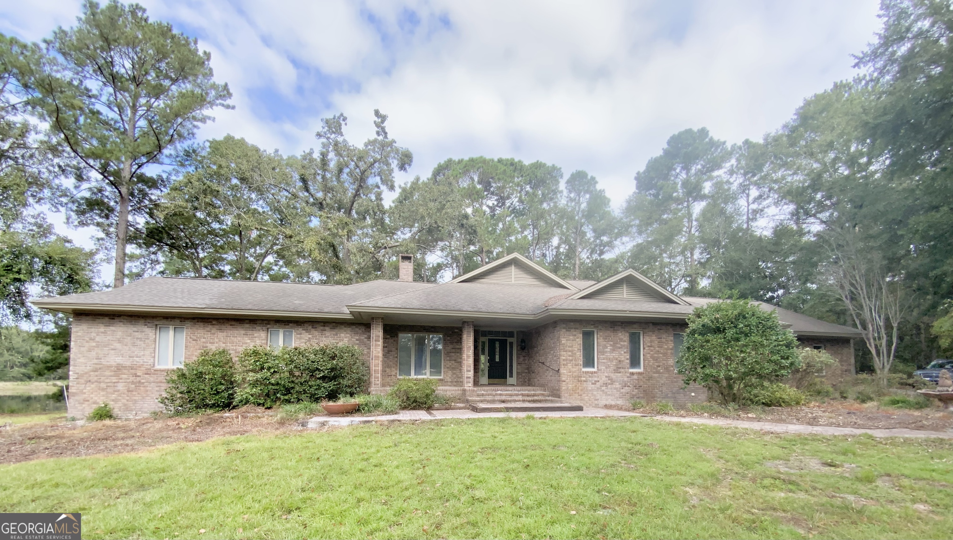 Home plus land! The sale includes two parcels: a home and 7.31 acres, with a second parcel of 23.61 acres. This property has it all. 3-bedroom, 3-bath brick house on 31 acres, a fully stocked four-acre pond that can be viewed from your beautiful dock and covered gazebo. The home features a split floorplan, a large primary suite with his and her bathrooms, one of which was recently remodeled, both equipped with a new tankless gas water heater. Each bathroom features its own walk-in closet with built-in storage. The family room has a tray ceiling, built-in cabinetry, and bookshelves, as well as a gas fireplace. The kitchen has tons of custom cabinets for storage, an island, and those special touches like a brass pot filler, ample bar space for additional sitting, and a separate dining area. If you like a big area to do your laundry, check that box. And if you need to work from home, there's an office with built-ins ready for that task as well. Other features include a two-car garage, one of the two air conditioners has been replaced, and a 40x70 pole barn, 12x24 separate garage, 30x30 utility building, boat dock, and mature pecan trees. What more could you ask for? Call now for your private showing. This property is priced to sell and will not last long.