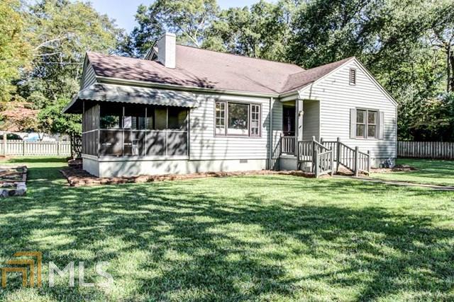 Charming 3bd/2bth bungalow within walking distance to the Smyrna Market Village featuring restaurants, retail shops and more! Beautiful features include hardwood floors throughout, crown molding, fireplace, updated kitchen w/ SS Appliances, granite countertops, breakfast bar, and much more. This home is on a great corner lot w/ a screened in porch, fenced yard and organic garden. Must see!