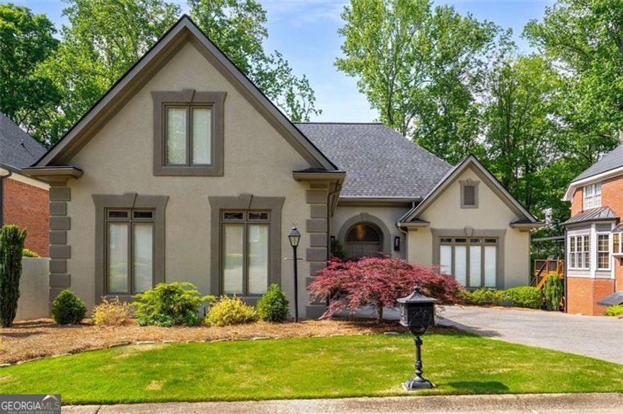 Where luxury meets livability-and entertaining comes with levels (literally).  Welcome to 4569 Fountain Drive, a masterfully designed six-bedroom, four-and-a-half-bath contemporary home in East Cobb's coveted Sope Creek Elementary, Dickerson Middle, and Walton High School district. High-end finishes define this residence-perfect for the buyer who appreciates modern design done right. Extensively renovated by the owners, including a beautifully finished basement, this home combines style and functionality at every turn.  The open-concept main floor offers seamless flow between living, dining, and kitchen spaces. The chef-caliber kitchen features Gaggenau appliances, sleek Italian cabinetry, and $80,000 worth of architectural lighting that elevates every detail. Hardwood floors, Jerusalem stone, and porcelain tile create an elegant backdrop, while the master suite on the main floor boasts a custom walk-in closet (and a built in wardrobe with drawers and abundance of shelving space), spa-like bath, and private deck access for tranquil mornings or evenings.  Upstairs, a spacious landing offers custom wood veneer shelving and a built-in desk. Hunter Douglas window coverings add sophistication and light control throughout.  The terrace level provides complete independence with its own private entrance, kitchen, bedrooms, bath, and living area-ideal as a mother-in-law suite, guest retreat, or long-term visitor space. It also includes a steam shower for added relaxation.  Outdoor living is where this home truly shines. Nearly 1,500 square feet of premium DuraLife composite decking surround the property, with spaces to grill, dine, relax, or soak in the Jacuzzi (included in the sale). A creekside pergola and fire pit create a serene atmosphere, while a built-in mosquito misting system and new drainage field ensure maximum enjoyment. Truthfully, we can't do the backyard enough justice-you just have to see it for yourself.  Tucked in a welcoming neighborhood near shopping, dining, and Abernathy Greenway Park, 4569 Fountain Drive offers craftsmanship, versatility, and timeless style at every turn.