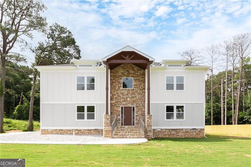 Welcome to this stunning new construction modern farmhouse, where timeless elegance meets today's luxury in the heart of East Lake Terrace! This stunning 5-bedroom, 5.5-bathroom modern farmhouse offers 4,056 square feet of beautifully crafted living space on more than an acre, perfectly combining elegance, comfort, and functionality. Located in one of East Lake's most established neighborhoods, you're just minutes from Barker Bryant Memorial Park, East Lake Golf Club, Oakhurst, downtown Atlanta, and a variety of shops and restaurants. Step inside to soaring ceilings and expansive natural light that highlight the open-concept floor plan. The spacious living room, complete with a cozy fireplace, flows seamlessly into a light-filled breakfast area and a stylish deck, perfect for outdoor entertaining. Off the back deck, enjoy your very own outdoor fireplace, creating a private retreat for year-round gatherings. The chef's kitchen features custom shaker cabinetry, gorgeous quartz countertops, stainless steel appliances, and a spacious walk-in pantry with a custom wine bar, designed for both casual evenings and sophisticated hosting. The main-level owner's suite or guest suite offers flexibility, featuring a walk-in closet and full bath, perfect for multi-generational living or a home office. Upstairs, the primary owner's retreat stuns with tray ceilings, a fireplace, and a luxurious en-suite bath with a soaking tub, oversized walk-in shower, dual vanities, and built-in closet organization. Let's not forget, in the primary the additional his-and-her suite provides flexibility and privacy, while three additional bedrooms and all have three full baths that offers ample space for family and guests. Outside, the oversized lot offers endless potential-imagine your own pool, basketball court, or pickleball court. A 3-car garage includes an EV charging station hookup for added convenience. Don't miss this rare opportunity to own a masterfully designed new construction home that truly has it the space, style, and an unbeatable location!