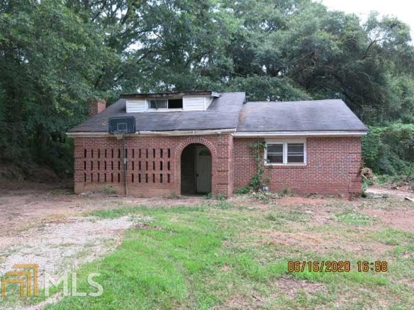 HIGHEST AND BEST OFFERS TO BE SUBMITTED TO LISTING AGENT BY 3 PM ON 8/28/20. Multiple offer form in the documents section needs to accompany the highest and best offer. 1 1/2 Story brick home that needs total renovation (from floor to roof) on 1.51 acres. Separate living room with fireplace. Kitchen with dining area. Large laundry room. Two bedrooms and full bath. Upstairs is a bonus room or 3rd bedroom. There is also a singlewide mobile home on the property that holds no value. No mobile home title. Sold AS IS. Prior to viewing the property, a Hold Harmless form must be signed and e-mailed to the listing broker. Proof of funds should accompany all offers. Earnest money must be certified check or wire transfer to listing broker or closing attorney.
