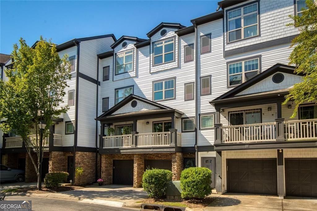 Surround yourself with the best of Atlanta! Located just between Buckhead & Midtown with access to the BeltLine Westside Trail. This unit has additional windows and additional parking. The one car garage has ample storage, access to the backyard area & additional parking in the driveway - enough for 2 cars. The main floor includes the open living & kitchen area with granite countertops and stainless steel appliances - new dishwasher & refrigerator. A powder room is also available on the main floor for guests. Upstairs you will find the secondary bedroom & ensuite bathroom with walk-in shower. Just past the stackable washer & dryer you will find the primary suite with vaulted ceilings, ensuite bathroom and ample closet space. Along with convenience, City Park Townhomes has a dog park and tennis court. Water, sewer & all exterior maintenance are included in the HOA fees. In town living at its finest.