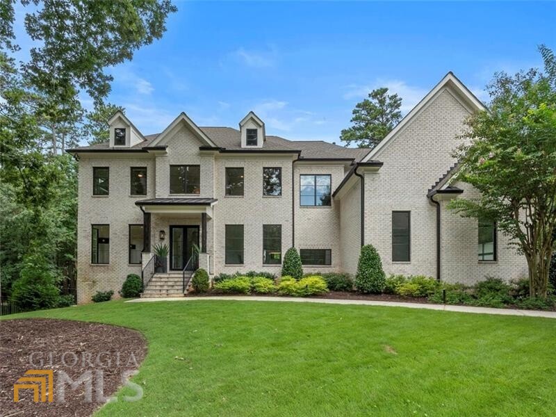 Custom Chastain Park home lies a flawlessly designed interior infused with an inspired pairing of natural elements and contemporary architectural details including metal windows and doors, wide-plank hardwoods, detailed millwork, and unique statement lighting. A bright, airy layout creates the ideal backdrop for a seamless indoor/outdoor lifestyle anchored by the smartly configured kitchen outfitted with a suite of premium appliances, Quartz countertops, and custom beaded inset cabinetry. Vaulted keeping room and living room opens to the covered Bluestone patio with skylights and a fireplace overlooking the heated saltwater pool and backyard. Oversized upper-level primary suite features a striking ledger stone-clad fireplace, morning bar, massive closet room, and stunning bath with dramatic open shower, luxurious soaking tub, and dual floating vanities. Daylight terrace level offers a tiered media room, game area, and private guest suite. Highly sought-after location, minutes to Chastain Park, Buckhead, and Sandy Springs.