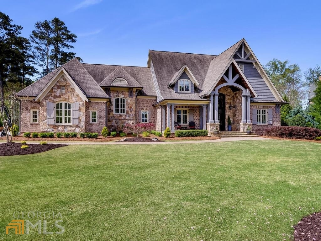 This spectacular home in the prestigious River Club is like new construction with amazing details and upgrades throughout sitting on just over an acre with a luxurious backyard oasis. From the moment you drive through the entrance gate, you feel true elegance and serenity in this unique community of winding streets and golf course views. This home overlooks the 4th tee of the Greg Norman designed golf course with a large front yard and fenced backyard perfect for gatherings and outdoor fun. As you enter through the double iron front doors, you find a marble floor foyer with a beautiful spiral staircase, wide plank white oak-stained floors. The formal dining room with wine cellar is perfect for family holiday dinners. Continue to the open floor plan with vaulted ceilings with gorgeous wood beamed ceilings, and a chefCOs kitchen any home chef would be inspired to cook in. The kitchen offers Wolf appliances, double Sub-Zero refrigerator and freezer, limestone hood vent, oversized marble top island with beverage refrigerator, 2 dishwashers, drawer microwave and plenty of countertop space for all your prepping needs. Turn the corner and slide open the barn door to your walk-in pantry sure to hold all your ingredients. Main floor also has floor to ceiling limestone fireplace, large laundry room, mud room with hidden closet, a chic office perfect as the house command center. Main bedroom features his and hers walk in closets, heated marble bathroom floors, soaker tub, large shower with a dedicated tankless water heater so you always have hot water for your 3 shower heads. The covered porch at the back of the home has an outdoor kitchen with an stone bar, Viking grill and vent hood, eating area, wood burning fire pit & retractable screens operated via remote control so you can enjoy the outdoors bug free. Upstairs you will find 4 en-suite bedrooms with wool carpet, walk in closets and a super convenient 2nd laundry room. The open terrace level features a media area with projection screen and 2 televisions perfect for game days. Pool table, bar with another television, sitting area with custom fireplace make this floor the party floor. You wonCOt mind getting in a good workout when you can relax in your steam shower with integrated aromatherapy also located on the terrace level. Then you walk outside to your 2nd covered area overlooking the large saltwater pool with 3 spillovers, 2 fire bowls, large tanning ledge, long shallow end for socializing, and an oversized hot tub (all less than 1 year old and all completely controllable using an app on your phone), large flat backyard with landscaping lighting highlighting your beautiful trees and Japanese Maple. Large mature trees give this home privacy without seclusion. If that wasnCOt enough, the home also has a 4-car garage, a man cave/office finished with a half bath and UV protected windows, upgraded Trane smart thermostats, upgraded alarm system with video surveillance, speakers installed throughout for whole home sound, tons of storage space with a large unfinished portion, radon system, landscape lighting in both front and backyard, whole home water filtration system, spray foam attic insulation, and more. All while in a resort style community with 3 restaurants on property, a spectacular golf course and driving range, 8 lighted tennis courts with a tennis pro, a basketball court, full fitness center, community pool with pool side bar, golf shop, tennis shop and more. With active community events such as glow in the dark pickleball, concerts, dining celebrations, pool parties, and block parties with food trucks, there is no reason to ever leave. Add in amazing school district and this is the perfect home.