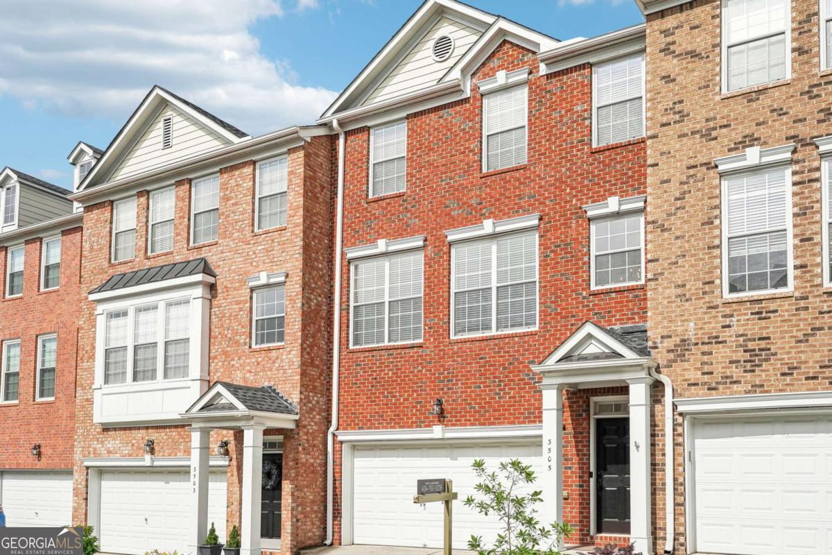 Updated Townhome with Finished Basement & Dual En-Suites in a Sought-After Atlanta Community. Welcome to this beautifully maintained and thoughtfully updated home with a finished basement, ideally situated in a vibrant Atlanta community featuring resort-style amenities including a clubhouse, fitness center, and sparkling pool, perfect for enjoying a connected and active lifestyle. Classic brick front, covered entrance, driveway, and a two-car garage. Located just minutes from shopping, dining, parks, schools, healthcare, and major highways, this home offers an easy commute and all the essentials at your fingertips. Step inside to an open-concept main level designed for both comfort and entertaining, featuring vaulted ceilings, dedicated dining areas, and a cozy fireplace to anchor the living space. The peninsula-style eat-in kitchen is equipped with granite countertops, a breakfast bar, and stainless steel appliances. A private deck just off the main living area is ready to be customized. Upstairs, the primary suite impresses with a large walk-in closet, dual vanity, elegant fixtures, and a stunning frame-less tile shower with a rainfall shower head. A second spacious en-suite offers a soaking tub and walk-in shower, ideal for guests or roommates. An additional full bedroom and a convenient upstairs laundry room round out the upper level. The finished basement provides a flexible layout for multi-generational living, a roommate setup, or creative space customization, featuring a spacious open bedroom, a full bathroom, and walk-out access to a covered patio. This townhome delivers space, style, and versatility, all in a well-appointed community that's close to everything Atlanta has to offer. Close proximity to to I-75, I-285, Vinings, Buckhead, Midtown, and within walking distance to The Battery and Braves Stadium. This move-in ready home combines luxury, convenience, and peaceful nature views in one of the most desirable areas around.