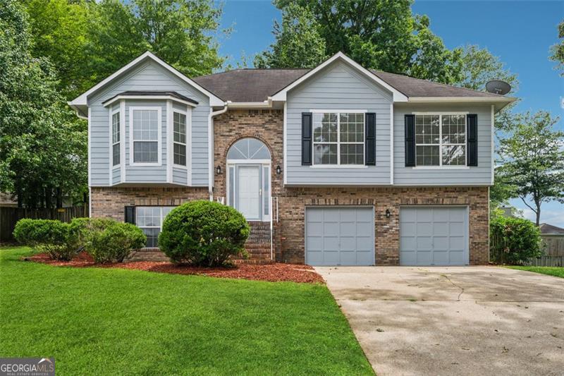 Welcome to 12290 Greenmont Walk, a spacious split-level home in a prime Alpharetta location. With 4 bedrooms, 3 full bathrooms, and flexible living areas across two levels, this home offers plenty of room to spread out and make it your own. Upstairs, you'll find a bright living area with refinished hardwood floors, fresh paint, and a functional flow from the dining space to the kitchen and breakfast nook. Step out onto the new deck-perfect for enjoying peaceful mornings or winding down in the evening. The primary suite includes a walk-in closet and en suite bath, while two additional bedrooms and another full bath complete the upper level. Downstairs, a versatile second living space awaits-ideal for a media room, office, or guest retreat-alongside a fourth bedroom, full bath, laundry, and a large utility area off the garage ready for storage or a workshop setup. With 1,606 square feet upstairs and an additional 624 downstairs, this home offers flexibility in a location that's hard to beat-just minutes from Avalon, downtown Alpharetta, and Wills Park.