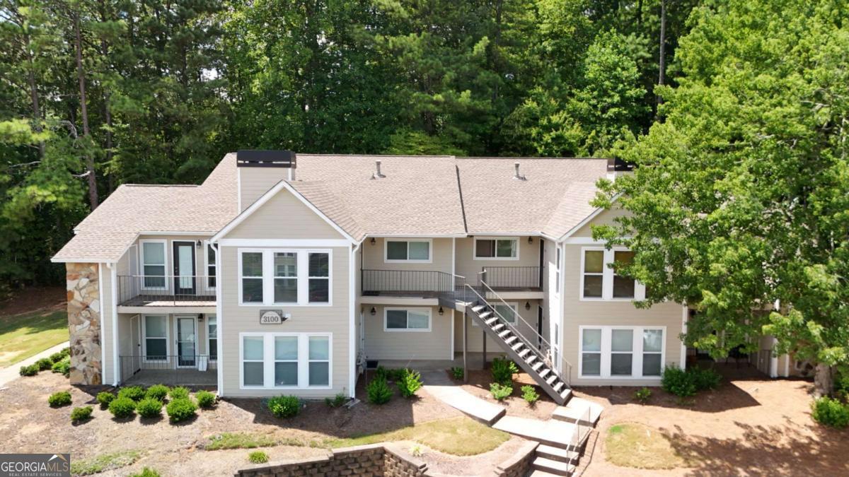 Beautifully maintained Roswell Condo in Prime Location! This lovely ground-level unit features quartz countertops in kitchen & owner's bath, stainless appliances, soft-close cabinets with pull-out trash & pantry, tile in all wet areas, Shaw LVP flooring (no carpet), designer lighting, LED can lights, and fandeliers in bedrooms. Elegant trim details at fireplace, owner's suite & guest bath, plus stylish wallpaper in owner's bath. Freshly painted with Sherwin Williams Duration washable-flat paint and upgraded brushed nickel hardware throughout. Enjoy a private, wooded view from the back patio. Community amenities include a lake with dock, pool, and ample guest parking. One assigned parking spot. Unbeatable location: just 2.5 mi to Downtown Roswell, 0.4 mi to shopping & gas, 2.4 mi to The Avenue East Cobb, and 2.6 mi to the Chattahoochee Nature Center. Move-in ready and truly a must-see!