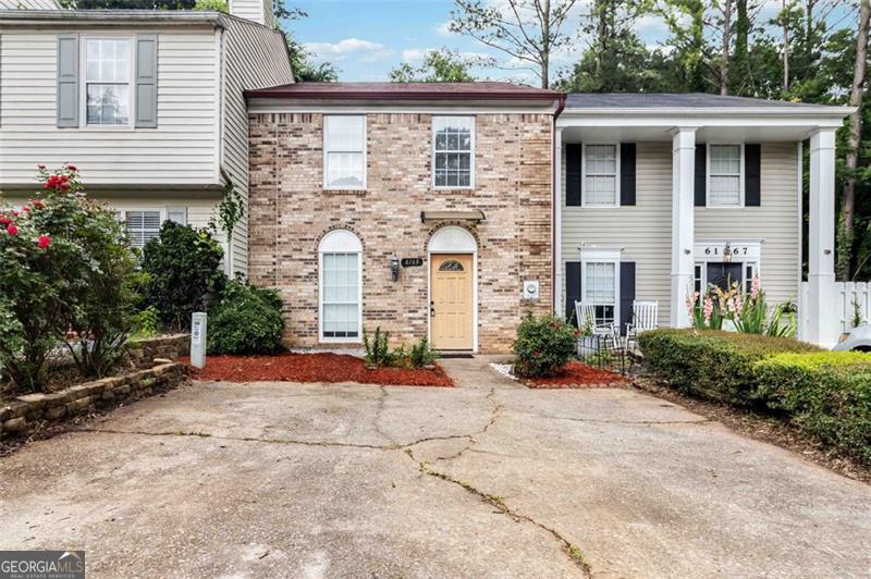 Beautifully updated, move-in ready townhome in the heart of Peachtree Corners! Located off Holcomb Bridge Road in a charming subdivision, this inviting 3-bedroom, 2.5-bathroom home offers a bright, open layout with freshly painted interiors and sleek laminate wood flooring throughout. The spacious living room features a cozy fireplace and flows into an enclosed sunroom with skylights - perfect for relaxing, working from home, or creating additional living space with storage potential. The renovated kitchen boasts modern finishes and ample cabinet space. The primary bedroom includes a private en-suite bathroom, while the two secondary bedrooms share a full hall bath. Additional highlights include a private fenced backyard, a laundry area with washer and dryer, and extra storage options in the sunroom. Enjoy an exceptional location just off minutes from The Forum on Peachtree Parkway, with easy access to a great selection of restaurants, shops, and entertainment. You're also close to parks, public transportation, and have convenient access to I-285, GA-400 North, Peachtree Industrial Blvd, and an easy drive to the airport. Don't miss the opportunity to make this charming townhome yours! This listing has been virtually furnished.