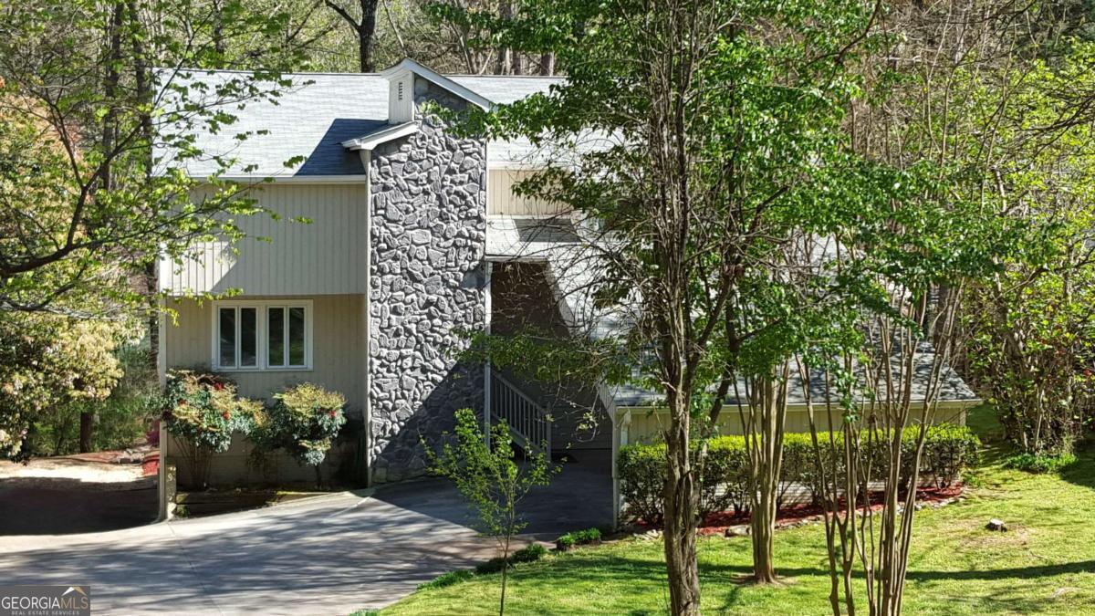 Stunning Lake House Retreat in Forsyth County! Escape to Your Own Private Waterfront Paradise! Discover the perfect blend of tranquil lake living and modern convenience at this beautifully renovated 3BR/3BA lake house in the Country Club Estates community. Nestled on the shores of Lake Lanier in Cumming, GA, this home offers an unparalleled retreat just minutes from urban amenities. Spacious master loft suite providing lake views and privacy. Two additional bedrooms and full baths, perfect for guests and family. Completely renovated throughout with fresh tile flooring, new carpet, and contemporary paint. Full basement offering abundant storage and potential recreation space. Two-car carport for convenient covered parking. Waterfront Luxury: The crown jewel of this property is the private double-decker dock featuring power, water connections, and a boat lift, making it effortless to enjoy all that Lake Lanier has to offer. Whether you're launching your boat for a day of water sports or simply relaxing with morning coffee overlooking the water, this dock transforms everyday living into a vacation experience. Unbeatable Location: Enjoy the serenity of lakefront living without sacrificing convenience. Publix and major retailers are just minutes away for everyday needs, while the upscale shopping and dining of Alpharetta awaits only 20 minutes down the road. For urban adventures, Atlanta's vibrant Buckhead district is a comfortable 45-minute drive, making this the ideal home base for both relaxation and exploration. Perfect for weekend getaways and extended stays, water enthusiasts with boats seeking a peaceful retreat with modern amenities or professionals wanting lake living with city access. Experience the best of Georgia lake country living in this turn-key rental that combines natural beauty, modern comfort, and prime location in one exceptional package!