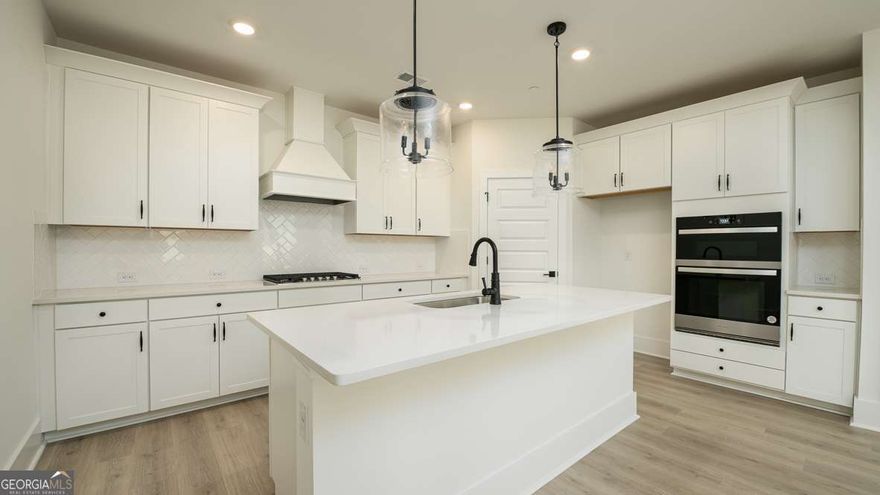 This stunning Harbor floorplan in East Cobb's newest gated community, Village at Sandy Plains, showcases a perfect blend of modern style and functionality. The open-concept plan offers 5 bedrooms and 4 baths in a layout ideal for entertaining. A spacious gourmet kitchen featuring sleek quartz countertops, a vented wood hood, stainless steel appliances, and a large island that flows seamlessly into the dining and living areas. The main living space on the first floor boasts 9-foot ceilings, finished with durable RevWood flooring that flows to wood stairs with an open railing. Upstairs, you'll find a versatile loft that's perfect for additional living or working needs. The oversized primary bedroom provides ample space for a sitting area retreat, while the secondary bedrooms are thoughtfully placed on the opposite side of the home for privacy, with a convenient Jack-and-Jill bath. Elevated finishes throughout the home, craftsman details on the exteriors and a gated swim community make this home a must see. Located in a prime Marietta location, this property offers easy access to the Marietta Square, top-rated schools, shopping, dining, and major highways. It's a truly extraordinary place to call home.