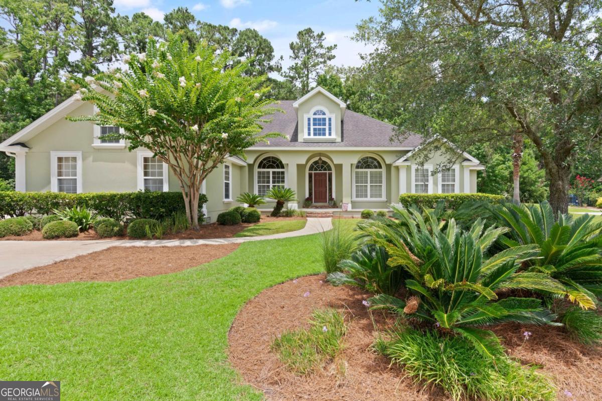 Welcome to 152 Old Wharf Rd-an exceptional single-level home in the gated Oak Grove Island community, offering over 3,100 square feet of thoughtfully designed living space. This 4-bedroom, 3-bath home features a flexible layout with a formal dining room, breakfast nook, and a cozy sitting room perfect for a home office or study. The spacious kitchen is the heart of the home, featuring custom wood cabinetry, granite countertops, a center island, and a seamless connection to the main living and dining areas-perfect for entertaining or everyday living. Step outside to a large screened back porch that overlooks a tree-lined, private backyard. The front yard is beautifully landscaped with mature trees and lush greenery that enhances the home's welcoming curb appeal. Recent updates include both HVAC systems (June 2025), new dishwasher and range, fresh exterior paint, and Wi-Fi-enabled garage door openers. Additional features include a 3-car garage, generous storage, and a mother-in-law suite set up. Oak Grove Island offers a host of amenities including a community pool, tennis and pickleball courts, playground, and optional golf and marina access with additional fees or membership. Come see the value and space this home offers-comfort, quality, and convenience all in one.