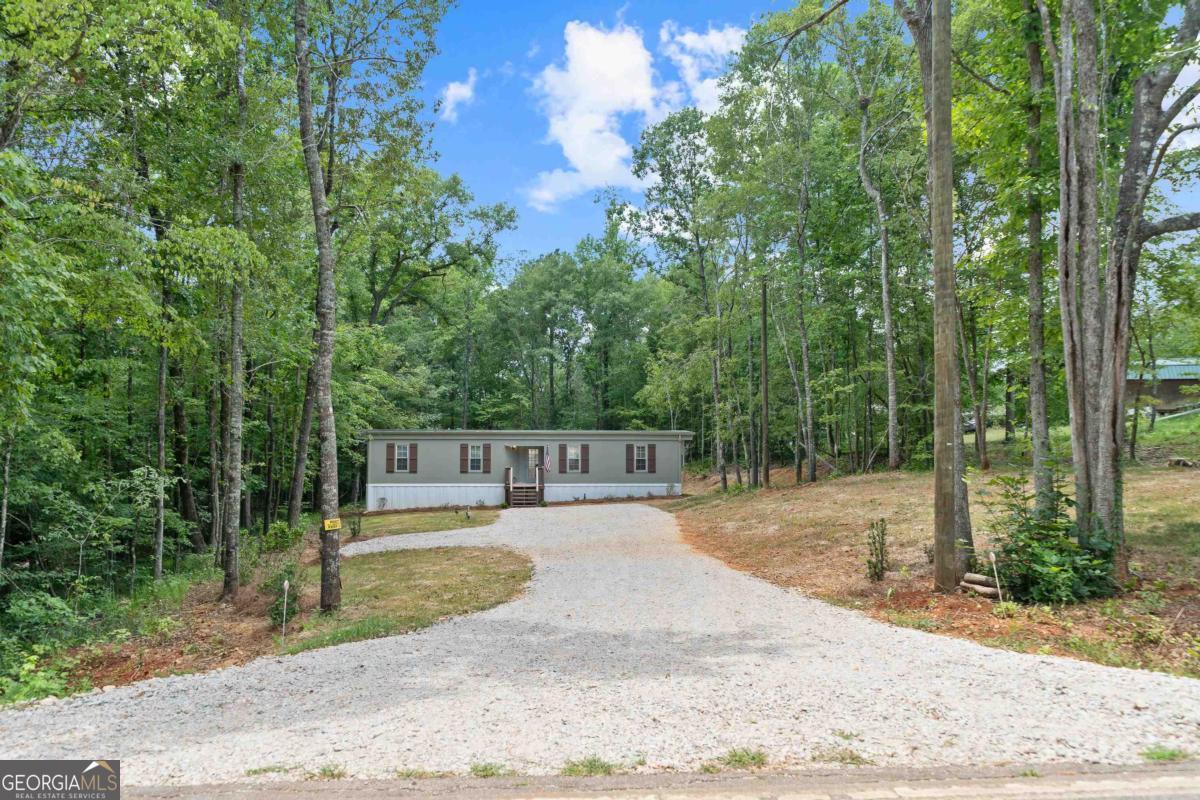 Charming Lake Sinclair Retreat - Updated & Move-In Ready! Discover the perfect blend of comfort, style, and location in this beautifully updated 2-bedroom, 1-bath Lake Sinclair area home. Freshly painted with premium Sherwin Williams finishes, this cozy retreat sits on a level, wooded lot with ample space to park your boat-front or back! Enjoy peace of mind with all-new plumbing, electrical, and a brand-new septic system. Inside, you'll find a fully renovated kitchen and bathroom, central heat and air, and even an attic fan for those hot summer days. Relax on the spacious back deck and appreciate thoughtful touches like cedar shutters and a roomy, level back yard. The home also offers washer/dryer hookups and an encapsulated crawl space. Just under a mile from the community boat ramp and 2 miles from Twin Bridges Marina-this home is your gateway to lake life. Come see it today before it's gone! Agent is related to homeowner.