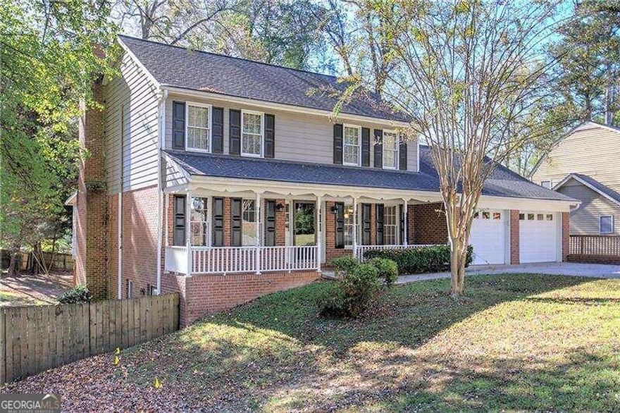 PRIME LOCATION - Welcome to 2864 Holly Oaks Dr, a charming traditional home nestled in East Cobb on nearly half an acre. Perfectly situated near the Davis Rd / Holly Springs roundabout, this home offers unparalleled convenience with walking distance to a variety of shopping, dining, and local amenities. Enjoy easy access to the Mountain View Aquatic Center, the Public Library, and some of the top-rated schools in Cobb County: Mountain View Elementary, Hightower Trail Middle, and Pope High School.    This 2-story traditional home boasts a thoughtful floor plan, starting with the rocking-chair front porch. Inside, you'll find an entrance foyer, formal living and dining rooms, a cozy breakfast area, and a kitchen that opens to a fireside family room. The sunroom is bathed in natural light and leads out to an expansive deck, perfect for entertaining, with stairs that descend to a fully fenced backyard.    The main level also features a kitchen-level, 2-car garage with bonus storage, a pantry, and a convenient linen closet in the laundry room.    Upstairs, the home is designed with a split bedroom layout. The private primary suite includes a spacious walk-in closet and a large en-suite bathroom, while two additional bedrooms share a full hall bath.    The finished basement offers a wealth of possibilities. With some updates to flooring and lighting, it can be transformed into a versatile space ideal for a multi-generational family, in-law suite, teen retreat, or even an income-generating apartment. The basement includes a second washer/dryer hookup, a recreation room with wet bar potential, a full bathroom, bedroom, storage room, and a kitchenette (with existing counters and sink, plus electrical connections for a stove). The expansive patio at the basement level spans the width of the home and connects to a convenient walkway leading up to the driveway.