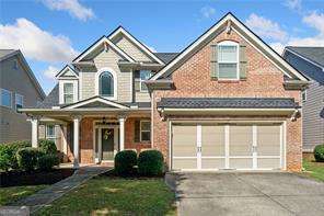 Welcome to your new home in the sought-after Grayson School District! This stunning 4-bedroom, 2.5-bath brick beauty is located in a picturesque neighborhood with tree-lined streets and easy access to parks, recreation, shopping, and dining. Step inside the inviting two-story foyer and fall in love with the bright, open floor plan. Beautiful hardwood floors flow on the main level, leading you into the spacious family room and the open kitchen featuring stainless steel appliances, plenty of cabinet space, and room to gather with loved ones. Your owner's suite on the main level offers a peaceful retreat with ample space and a luxurious ensuite bath. Upstairs, discover a versatile loft area-perfect for a home office, study space, or homeschool setup-plus three additional bedrooms. One of the bedrooms has direct access to the full bathroom, making it ideal for guests or older children. Enjoy quiet mornings or rainy afternoons on the cozy front porch, or host backyard fun in your private, fenced yard. This home combines comfort and convenience in a family-friendly community with top-rated schools, tree-lined streets, and easy access to outdoor activities. Don't miss your chance to own this beautiful home in an unbeatable location. Schedule your showing today!