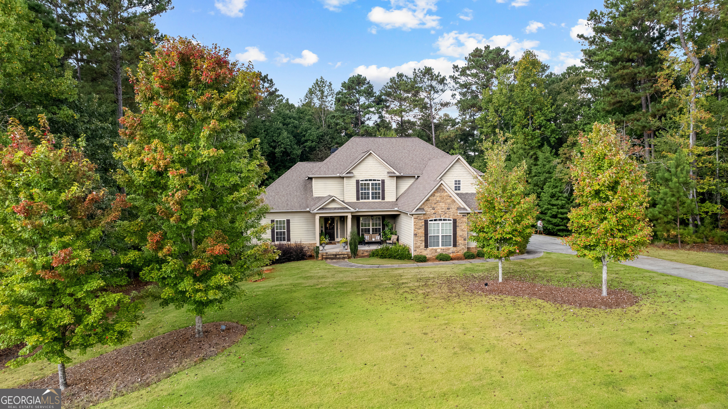Located in the gated River Club community, this custom-built lakefront home offers 4 bedrooms, 4.5 baths and approximately 3,400 square feet of finished living space with an additional 2,000 square feet of unfinished basement ready for future expansion. The main level features an open floor plan with hardwood flooring, a two-story family room with wood burning fireplace, separate dining room, and an open kitchen with granite counters, island, gas cooktop, and custom cabinetry. The primary suite on the main level includes a fireplace, balcony with lake views, large walk in tile shower, double vanity, and jetted tub. Upstairs offers three additional bedrooms including one ensuite, a Jack and Jill layout, and a large bonus room. Outdoor living includes a covered back porch with stone fireplace overlooking the manicured backyard and West Point Lake. Additional features include a 3-car garage, private covered dock with slip and lift, and a rear roll up garage door perfect for lawn equipment/workshop or golf cart storage. Neighborhood amenities include pool, clubhouse, and tennis/pickleball courts. A Must See on West Point Lake!