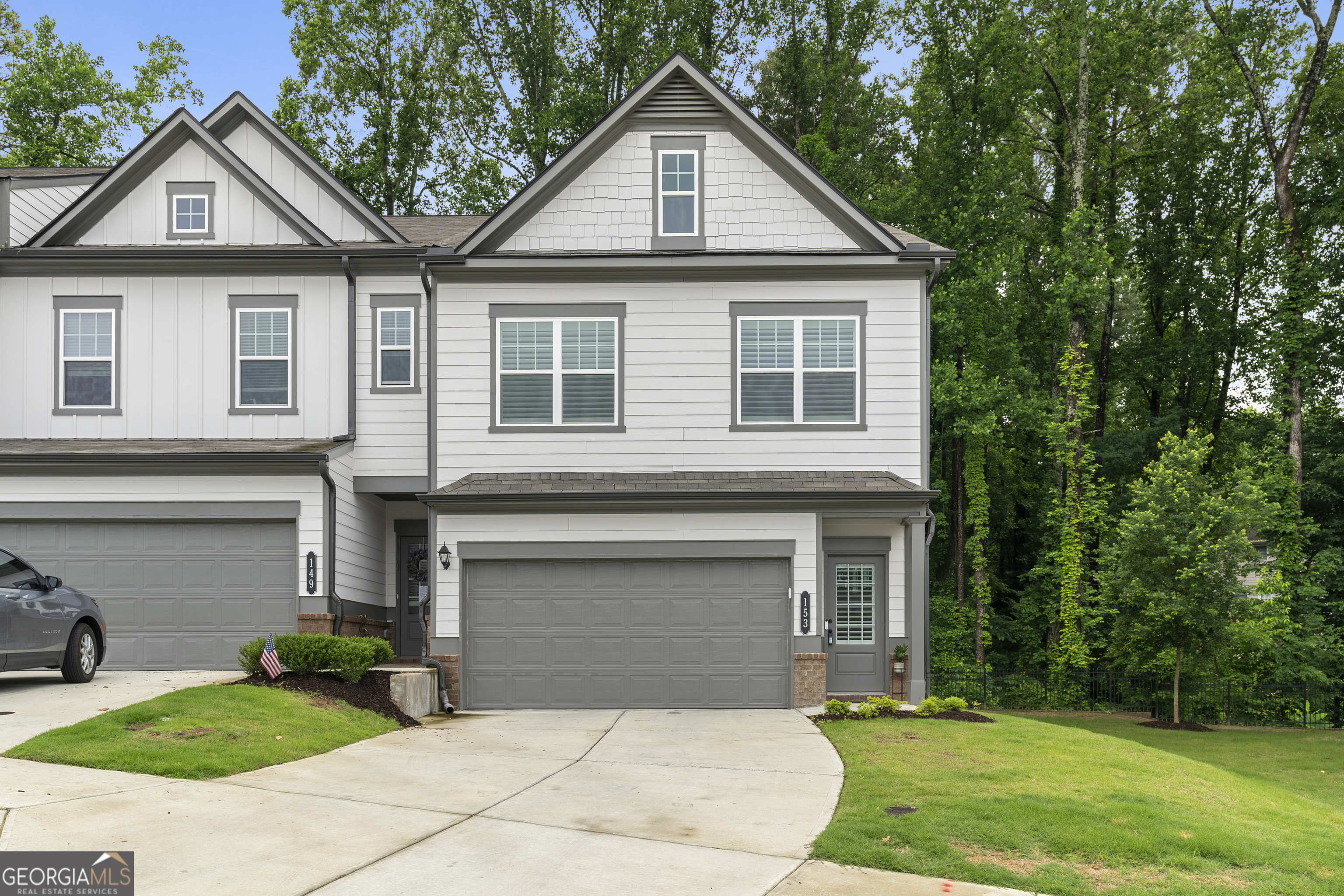 This beautifully upgraded end unit townhome is perfectly situated in the highly sought after Concord community, just minutes from Downtown Woodstock! From the moment you arrive, you'll notice the natural light streaming through large windows, highlighting the rich hardwood floors and custom touches throughout. Plantation shutters add a classic feel, while the spacious living area is anchored by a custom fireplace that creates a cozy yet sophisticated focal point. The kitchen is both functional and stylish, featuring a large center island, stainless steel appliances, quartz countertops, white cabinetry with brushed brass pulls, and striking pendant lighting. Whether you're prepping dinner or hosting friends, this space is designed to impress. Upstairs, the primary suite offers a peaceful retreat with an upgraded ensuite bath showcasing dual vanities, a sleek frameless glass shower, and matte black fixtures for a clean, modern look. Two additional bedrooms and an updated full bath provide versatile space for guests, a home office, or additional family needs. Additional features include matte black hardware throughout the home; on doors, faucets, and bathroom fixtures, plus a marble top vanity in the guest bath, replacing the original pedestal sink. The two car garage has been enhanced with epoxy flooring and custom shelving for added storage. A private back deck offers the perfect spot to unwind outdoors. Set within a dog friendly community that includes sidewalks and streetlights, this home offers the ideal combination of upgraded living and everyday convenience. With schools, shopping, dining, and entertainment just around the corner, this one has it all!