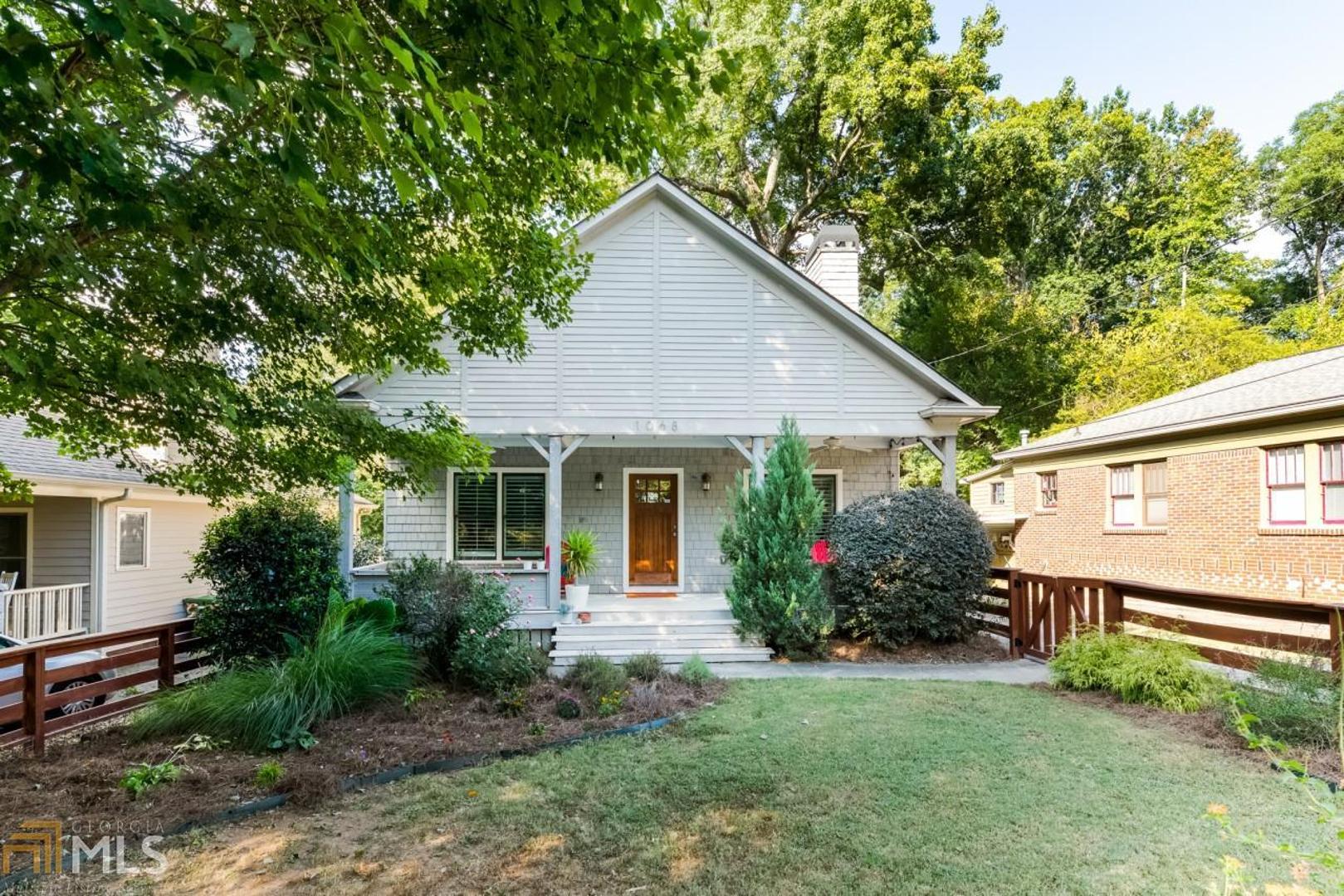 Newer construction Ormewood Park charmer with custom finishes & great flow! This architect's home was built in 2006 & boasts expansive front porch + deck with cheerful cedar shake exterior. Open living room with fireplace flows into separate dining room; well-appointed kitchen with white cabinets + granite; private master suite with walk-in closet. Dedicated laundry, powder room, & fenced front & back yard. The bright windows with verdant views, hardwood floors, & custom carpentry details, including built-ins, trim work, & plantation shutters, make the inside a dream!