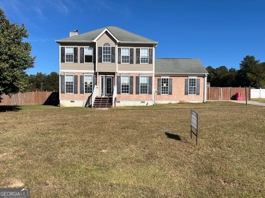 Investor special or perfect opportunity for a buyer looking to finish renovations and add their own touches! Located directly across from Westside High School, this 3-bedroom, 2.5-bath, two-story home sits on a .71-acre fenced corner lot with plenty of outdoor space and privacy. The main level features a spacious great room with a fireplace, formal dining room with French doors, and a kitchen ready to be completed to your liking. Upstairs includes large bedrooms, a primary suite with soaking tub, dual vanities, and an unfinished tiled shower awaiting your final design. Updates already started include new flooring throughout, fresh paint, modern bathroom tile, and updated fixtures. The property also offers a detached outbuilding previously used as a studio or bonus living area, perfect for a home office, guest suite, or rental space. With much of the work already underway, this property is ideal for an investor or handy buyer ready to bring it across the finish line. Conveniently located near shopping, schools, and I-475 access, this home combines great potential with a prime north Macon location.