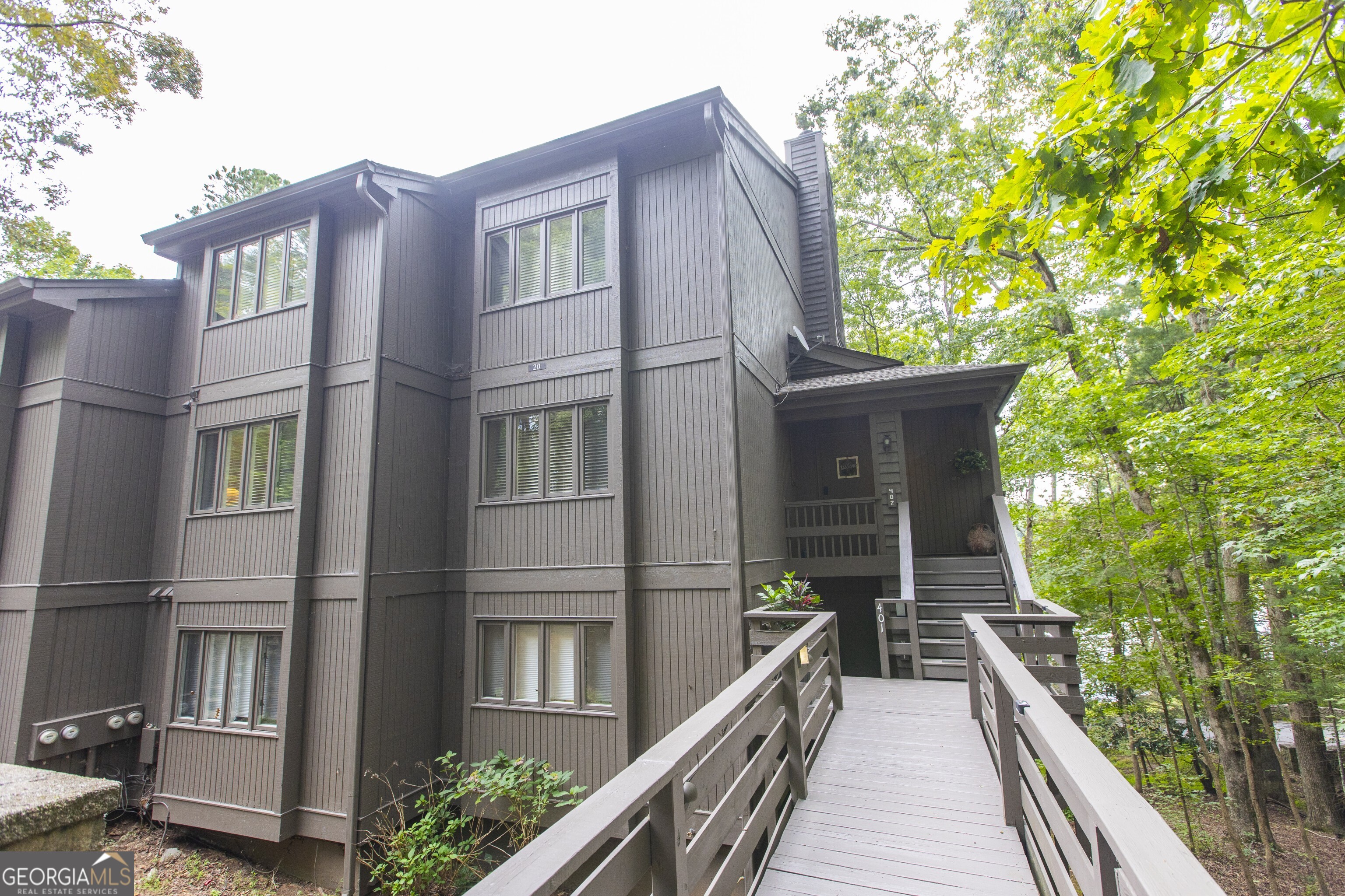 Welcome to your mountain retreat in the heart of Big Canoe! This beautifully updated 3-bedroom, 2-bath condo offers the perfect blend of comfort, style, and versatility. Fully updated interior, the home has also been thoughtfully enhanced with a new HVAC system and durable Luxury Vinyl Plank (LVP) flooring. The home features plenty of closet space, open concept Living Room with a stone fireplace and built-in bookcases, a large kitchen with solid surface counters, pantry and dining space. The Primary Bedroom features an on suite bathroom, three closets, a sitting room and mounted tv that can be swiveled towards the bed or towards the sitting room space. Upstairs are two guest bedrooms with a shared bath are on the upper level. Step out onto the screened-in balcony overlooking serene Sconti Lake-ideal for sipping your morning coffee or unwinding with evening tea. The removable screening panels make seasonal cleaning and open-air enjoyment a breeze. Offered fully furnished and turnkey, this condo includes a locked Owner's Closet and has a strong rental history, especially popular during Big Canoe's vibrant wedding season. Whether you're seeking a smart investment, a peaceful vacation home, or a full-time residence, this property checks every box. For added peace of mind, fire escape ladders have been installed in the Condo's main floor primary bedroom and upper floor bedroom, and fire extinguishers are placed in convenient locations throughout the unit-ensuring safety is never compromised. Enjoy access to both Sconti and Disharoon Lakes with beach, sliding rock, kayaking, and swimming. Access to some amenities provided at discounted rates for owners. The community also features a saltwater swimming pool, championship golf course, brand new clubhouse, fitness center, tennis, pickle ball, bocce ball, scenic hiking trails, and a variety of social clubs and events to connect with neighbors and nature alike. Don't miss this opportunity to own a slice of paradise in one of North Georgia's most sought-after gated communities!