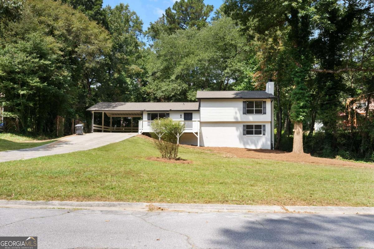 Stunningly renovated 4 bed/2 bath featuring brand new Luxury Vinyl Plank flooring, brand new 30-yr Architectural Roof, new HVAC, new interior and exterior paint, new lighting and plumbing fixtures everywhere, new granite countertops in kitchen and bathrooms, and new stainless-steel appliances. Home offers beautiful curb appeal with a 2-car carport and large front porch. Enter into the large open floorplan living room offering large windows to allow in lots of natural lighting and views to the kitchen. Kitchen offers new granite, plenty of cabinets and countertops space, island with overhang perfect for barstools, stainless steel appliances, and large eat-in dining area. Master bedroom offers an En-suite with tub/shower combo, new granite on the double vanity, and low flow toilet. Two good sized secondary bedrooms and secondary bathroom upstairs with walk-in shower, low flow toilet, and new granite. The basement offers a large recreation room/den/second living room with fireplace and 4th bedroom. Out back the deck overlooks the large backyard and storage shed.