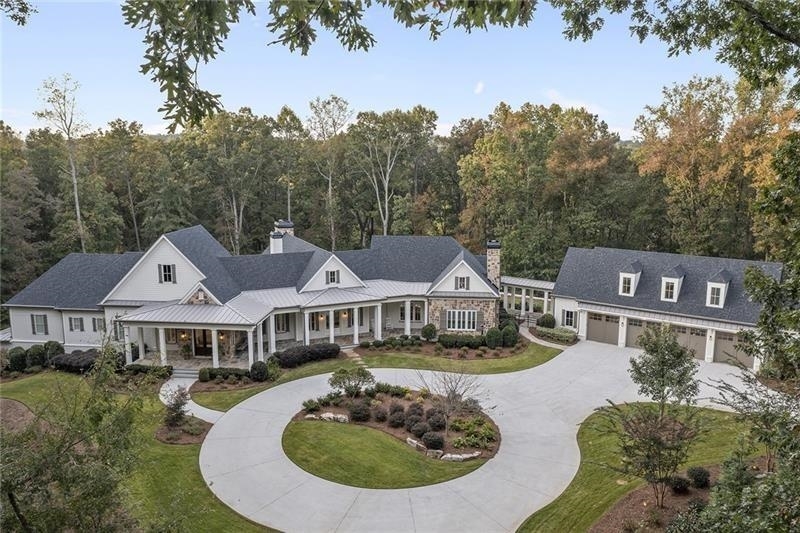 This Private Wooded Estate, by Timothy Bryan Architect, was completed with Smart Home Technology and distinctive features by Cole Construction. Located minutes from Milton and situated on 12.5 acres, this entire home and exterior spaces are an Entertainer's Dream. Featuring a lavish swimming pool with extensive decks and verandas, additional details include Gated Entry, Guest Apartment, Elevator and Car Barn for 6+ vehicles. This fully automated home utilizes Lutron controls for LED Lighting and Motorized Curtains, SONOS, Security Cameras, any many more custom features. Planned as a 'Reverse Ranch' the Owners' wing is located on the main level with two vanity rooms, dual toilet rooms, two dressing room closets, built-in for linens, and 2 additional closets with custom shelving. Glass enclosed shower is 8'x7' with Rain Shower head, 2 wall shower heads, and handheld sprayer. Enjoy Calacatta Oro Marble, Porcelain Tile, and Glass Mosaic Tile. White Oak Flooring was fumed with Rubio Monocoat oil finish and expands throughout the Main Level. Solid White Oak Beams accent the ceilings in the Dining, Living and Keeping Rooms. Entertain family and friends in the expansive Dining Room with Living Room (seats 28+) and large glass sliding doors to patio. Open floor plan includes Chef's Kitchen with stainless appliances, island with Quartz and polished solid Hickory Countertops, and cozy, eat in dining. Terrace Level has Suite with curb-less walk-in shower and ADA wide doorways. 2nd Suite is separated with patio accessed living room, and secondary bedroom suite. 3rd Terrace Bedroom has private bathroom and French doors. Entertaining areas include: Glass Lighted Bourbon Display and tasting area, Media Great Room with Wet Bar, Billiard Room, Gym, and Art Gallery.