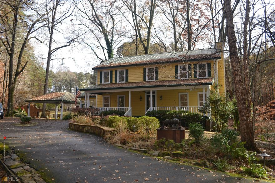 Picturesque 4.08 acres just minutes from Suwanee City Center. Nestled among other million dollar estates on a single, tree lined cul-de-sac street. Home situated at the end of a long, winding private drive. This Mini Horse Farm includes a two-stall barn with tack room, corral and a barn/workshop which offers two additional covered parking spaces for all your toys! Two fenced pastures with wooded perimeter and gazebo. Farmhouse style home with a metal roof and front porch with swing is large enough to enjoy outdoor entertaining. This home includes four bedrooms and two and one-half baths on an unfinished basement. Hardwood floors on main, large Great Room with separate dining room. Country kitchen with breakfast area, sunroom and covered back porch all overlooking a fenced, landscaped courtyard. Upstairs is the large Owner's Suite with a walk-in closet and a steam shower, along with three additional bedrooms. One of the secondary bedrooms was converted to a large laundry room but it can easily be converted back with the possibility of adding a bathroom. Full hall bath features a whirlpool tub. The unfinished basement offers an extra area for storage and garage space for two cars. Additional parking available with a detached two-car covered carport at kitchen level. Expansion opportunity for primary residence and/or zoned for a Carriage Home.