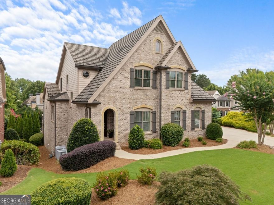Discover exceptional value in this enchanting home at a newly reduced price of $995,000. Nestled within the storybook-like Cottages at Creekstone, this residence offers a perfect blend of charm and practicality. Adjacent to Creekstone Estates, enjoy shared amenities including hassle-free lawn maintenance.  This residence stands out not only for its unique beauty but also for its superior, energy-efficient construction featuring durable concrete roofs. The Primary on Main home showcases exquisitely appointed rooms with ample space to cater to your lifestyle needs.  Crafted with immaculate attention to detail, this four-sided brick home boasts a spacious chef's kitchen equipped with SubZero and Thermador appliances, accentuated by spectacular crown molding and coffered 11 ft. ceilings. Gleaming hardwood floors (refinished just 2 years ago!!) span throughout, leading to a vast finished basement with countless storage options, a kitchenette with granite countertops and private entrance, and a 3-car garage with epoxy flooring. Additional features include three accessible attic storage areas.  Families will appreciate the top-tier local schools and the extensive Creekstone Estates amenities, including a Jr Olympic pool, tennis courts, pickleball, a clubhouse, playground, fishing, and organized sports and activities for all ages. Embrace a country club lifestyle in an idyllic setting-this home and community offer an unrivaled living experience in Forsyth County. Don't miss this opportunity to own a piece of paradise at an incredible price.