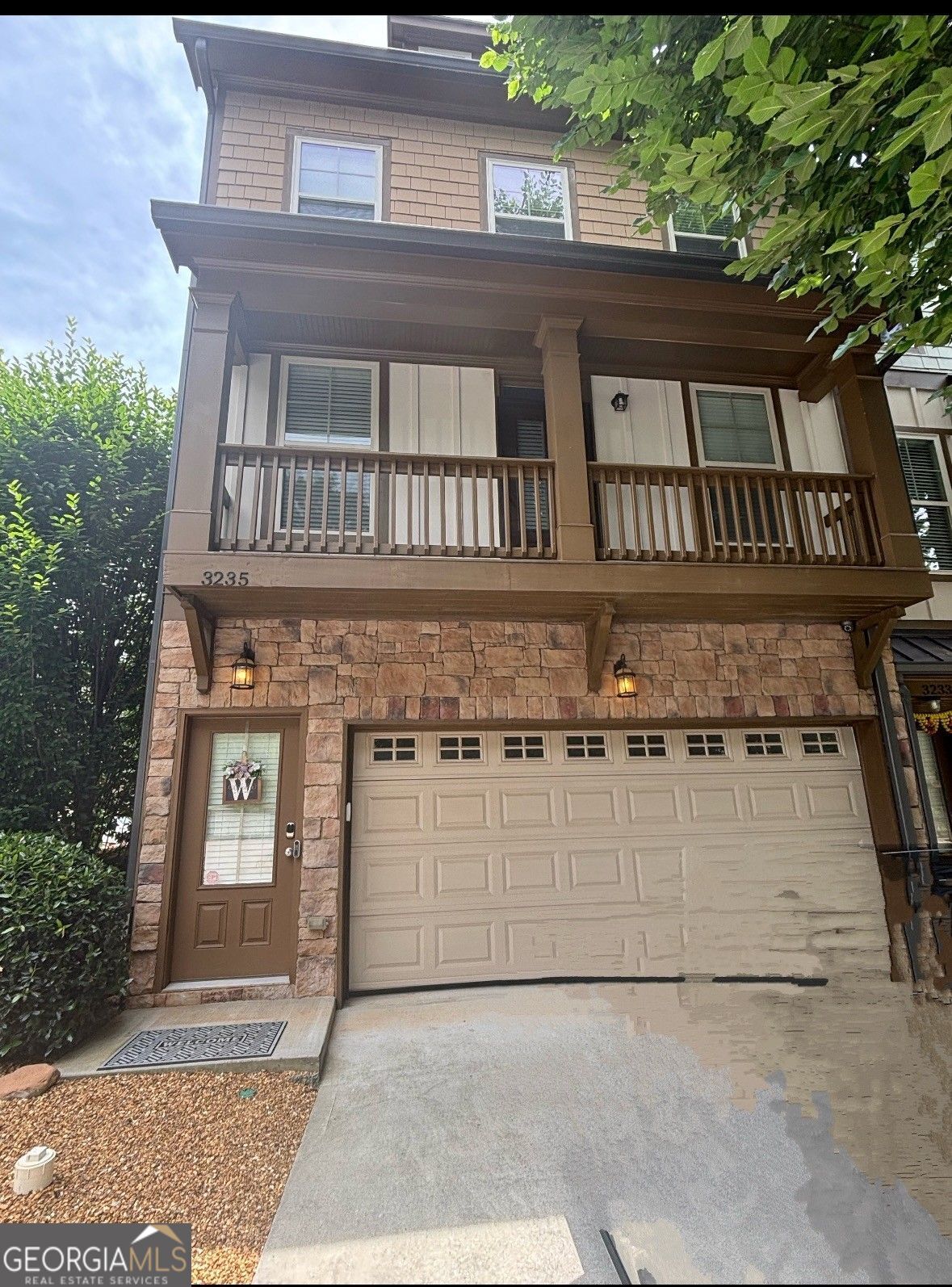 Beautiful END-UNIT Townhome in Sought-After Berkeley Village, Avondale Estates Freshly painted 3-level end-unit townhome - perfect for first-time buyers or empty nesters looking for low-maintenance living close to the city. Built in 2015 and maintained by its original owner, this home offers a flexible, open layout with great indoor/outdoor flow. The main level features a large kitchen with stainless steel appliances (refrigerator less than 2 years old), granite counters, and a huge island with storage and bar stool seating- perfect for casual meals or entertaining. Enjoy morning coffee on the front deck off the kitchen, and host friends on the larger rear deck overlooking the peaceful, tree-lined backdrop and lower-level patio. Upstairs, the spacious primary suite includes a double door entry to the bath, spa tub, separate shower, dual vanities, and a large walk-in closet. A second en-suite bedroom is also upstairs, offering great flexibility. On the terrace level, a third bedroom with full bath and backyard access is ideal for guests, a home office, or gym. Additional features: 2-car garage, walk-in closets, gas fireplace, and a bright, open living space. Community offers low monthly HOA fees ($250) and is walkable to vibrant Downtown Decatur, Avondale Lake, Town Green, restaurants, shops, and MARTA, with quick access to Emory and CDC. Enjoy the best of in-town living in a quiet, friendly neighborhood. Don't miss this rare end-unit opportunity!