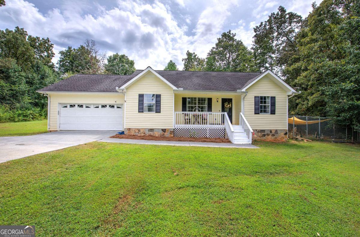 Welcome to 191 Frix Lane in Calhoun, a charming ranch-style home offering comfort, convenience, and plenty of space inside and out. Set on nearly an acre, this 3-bedroom, 2-bath property greets you with a classic rocking-chair front porch that enhances its curb appeal. Inside, the home features a bright and inviting living room that flows into a spacious dining area and a well-appointed kitchen with generous cabinet storage. A large laundry room, practical mudroom, and attached two-car garage add everyday convenience. The bedrooms are thoughtfully arranged to provide comfort and privacy, while the open layout creates a natural flow throughout the home. Step outside to discover the expansive backyard, perfect for entertaining, gardening, or simply enjoying peaceful afternoons in your own private retreat. With its wide-open lawn and quiet surroundings, this outdoor space is a true highlight. The property blends timeless design with easy upkeep. Its location offers the best of both worlds-tucked away in the serene Plantation Place neighborhood, yet just minutes from I-75, shopping, dining, and schools, including Red Bud Elementary, Red Bud Middle, and Sonoraville High. Move-in ready and full of charm, 191 Frix Lane is a wonderful opportunity for anyone seeking a welcoming home with a spacious lot in a desirable Calhoun location.