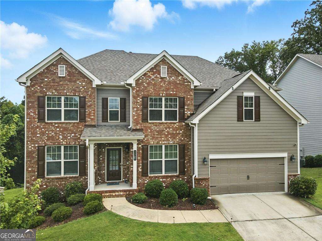 Welcome to a beautiful Craftsman-style home in the desirable Grandview Manor community in South Forsyth County. As you enter, abundant natural light floods the home, highlighting hardwood floors and a central gas-log fireplace-perfect for cozy evenings or entertaining. An adjacent room, functional as a guest suite or ideal for multi-generational living, opens off the main level and is thoughtfully complemented by a flexible living room or office with French doors-ideal for a quiet reading nook or work-from-home. The eat-in kitchen flows smoothly into the family and breakfast area and features granite countertops, stylish tile backsplash, an island with seating, and stainless steel appliances including a double oven-a chef's delight. Upstairs, the generous primary suite is a serene sanctuary with a dedicated sitting area and crown molding throughout the home. The spa-inspired ensuite bath includes granite countertops, tile flooring, a jetted soaking tub, and a large glass shower. Three additional bedrooms, a second full bath, and a convenient laundry room complete the upper level. The daylight basement is unfinished but spacious-ready for a media room, guest quarters, fitness studio, or workshop to suit your needs. Outside, the fenced backyard features a deck off the breakfast area overlooking open and tranquil surroundings. A 2-car garage provides convenient, secure access to the kitchen level. This home is ideally situated for those who appreciate both active and leisurely lifestyles. Just minutes away, residents can enjoy the Big Creek Greenway, a scenic, paved trail that stretches nearly 10 miles through Forsyth County-perfect for walking, jogging, and biking. Nature lovers will appreciate easy access to Sawnee Mountain Preserve, featuring miles of wooded hiking trails, an observation deck with panoramic views, and an educational visitor center. Fowler Park offers a wide variety of recreational amenities, including sports fields, tennis courts, a skate park, playgrounds, and picnic areas-perfect for weekend outings or everyday fun. For water enthusiasts, Lake Lanier is just a short drive away offering lakeside relaxation. Beyond the outdoor activities, the community enjoys proximity to local shopping, dining, seasonal festivals, and entertainment in downtown Cumming. Families also benefit from access to highly rated schools, making this an ideal place to call home. This home combines thoughtful design, functional living spaces, and a strong community lifestyle-all in a serene and amenity-rich setting. If you're looking for comfort, quality, and connection, this Grandview Manor gem is sure to delight-welcome home.