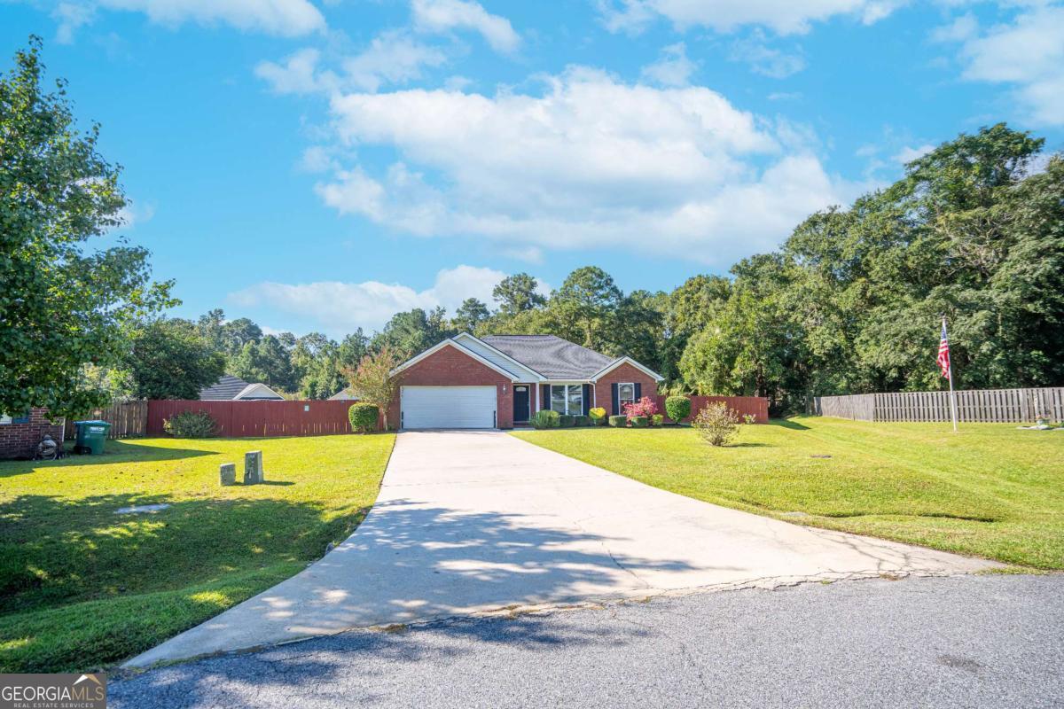 This well-maintained, full brick, split floor plan home is perfectly situated on a beautiful .51-acre fenced lot in a quiet cul-de-sac with amazing curb appeal. Step inside to an inviting entryway that leads to a spacious Great Room with tall vaulted ceilings, a cozy fireplace, and plenty of natural light. The large eat-in kitchen serves as the heart of the home, offering ample space for gatherings, cooking, and dining. A split bedroom design ensures privacy for the owner's suite while maintaining a smart, functional flow for everyday living. Outside, the expansive fenced backyard provides endless possibilities-perfect for entertaining, gardening, or simply relaxing in your own private retreat. With the added convenience of no HOA, no well, and no septic, and bst of all a brand new HVAC! This Guyton gem truly has it all!