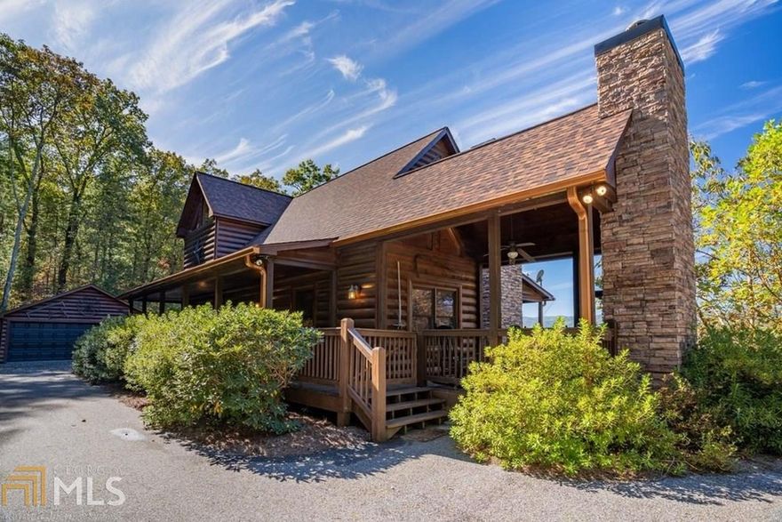 Gorgeous Mountain Cabin sits atop exclusive Crockett Mountain in Cherry Log. Take in a jaw dropping view from the wrap around deck and spacious sitting area with outdoor fireplace. This beautiful cabin boasts soaring cathedral ceiling, river rock fireplace, 3 levels of decking, two master suites and a fantastic finished terrace suite w/ 3rd bedroom, kitchenette & large living area w/ new fireplace. Large paved driveway with detached matching garage makes for easy access parking & turn around. Located on 2 acres just minutes from Blue Ridge & Ellijay. New roof & gutters, high end whole house generator, recently stained and expertly decorated. This home is move-in ready! Furnishings negotiable by separate bill of sale.