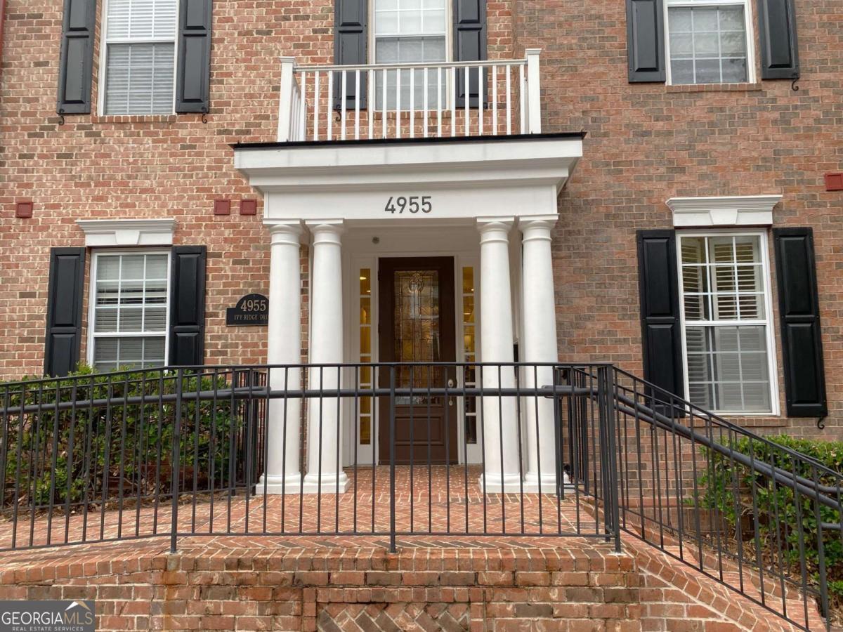 Do not miss this gorgeous condo that's very well maintained with open floor plan, hardwood flooring and a private, peaceful, wooded view. This building has no steps to climb to the front door, plus there is an elevator down to the parking garage making this place truly "Living with no stairs". Spacious kitchen with all appliances replaced during their ownership. Kitchen features stainless steel appliances, granite countertops, tile backsplash, stained cabinetry, recessed lighting, breakfast bar, and built in Microwave. Open concept formal dining room. Large great room with built-in shelving, decorative columns, and marble fireplace with gas logs. Large master bedroom with built-in shelving, crown molding, access to the private balcony and spacious walk-in closet. Master bathroom features tiled flooring, double vanity, glass framed tile shower and whirlpool tub. Spacious secondary bedroom with great closet space. Bonus room works well for an office or separate TV room. This unit comes with an assigned parking spot along with a storage closet and Tesla charger which is universal allowing other EV cars to be charged. The washer, dryer and refrigerator will be staying. The rental cap for this complex is 25% and it's currently at less than 14%. Great clubhouse community activities include a Book club, football game parties and holiday parties. This is a very popular gated community with great amenities, including a large swimming pool, fitness center, walking trails and in a great location within minutes of 285, I-75, Atlanta and airport.