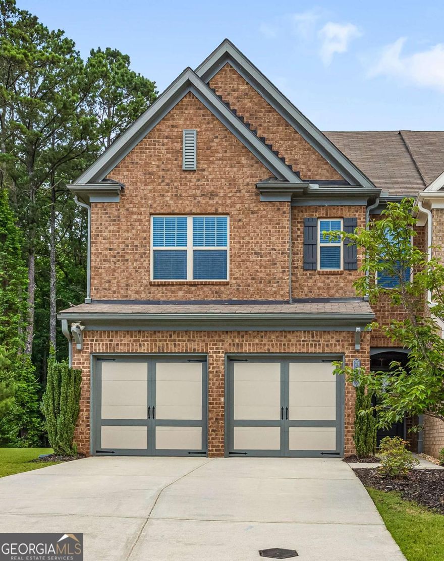 Welcome Home to your beautiful, well maintained, one owner home. 3 story 4 bedroom 3.5 bath END UNIT town home is the Chastain model. As you enter the 2 story foyer with gleaming dark hardwood floors which follow throughout the main level, it leads to open concept living. The bright kitchen is open to the family and dining room. All stainless appliances, gas stove with 5 burner grates, granite counters and tile back splash complete this space. The 4 door refrigerator, washer and dryer remain in the home. The dining and family room share a wall of windows for tons of light and overlook the wooded back yard. Cozy up next to the fireplace on cold nights. The 2nd floor has a staircase with wrought iron spindles and at the top is a large loft that can be used in so many ways. 3 bedrooms are on the 2nd level and the master is oversized with large windows, a private en suite with double vanities, soaking tub, separate shower and a large walk in closet. The 2 secondary bedrooms are large also.  The 3rd floor boasts a huge room that is the 4th bedroom or can be a teen, media, play, craft, office, or exercise room. So many options for this space.   There is a full bath, walk in closet and TONS of floored space for storage in the attic surrounding this room. The couch, media screen and projector remain with the home. Outside you will find a nice inviting back and side yard. Great place to play or entertain. Close to GA 400, schools, shopping, restaurants, Halcyon and so much more. Don't miss out on this fantastic home that offers so much. Schedule your private showing today!