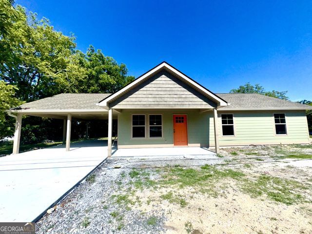 New Construction Right in the heart of town, close to restaurants, grocery, walking distance to the duck pond. This home has a great layout. Open living room and kitchen, island in the center of kitchen, can lights, beautiful cabinets and butcher block tops. Gorgeous! 3 bedrooms and 1 large full bath. Would make a great starter home or great for someone that needs one-level living. Carport is on the same level as home and it also has a large covered rear patio and covered front porch. Lot is a great size for kids to play or dogs to run around. Agents are related to seller.