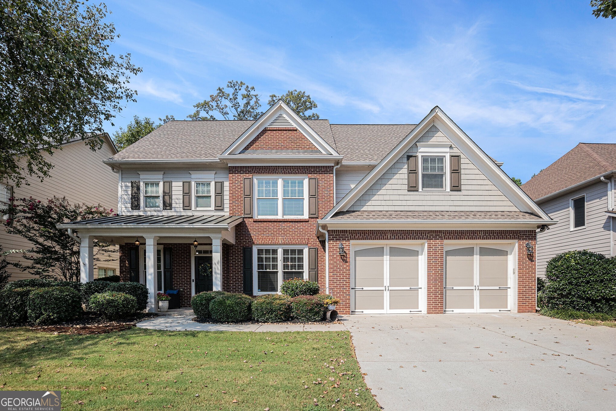 Stunning Traditional South Forsyth Home in the highly sought-after Liberty Community! Residents enjoy top-tier amenities including a Clubhouse, Fitness Center, Olympic-Sized Pool, Playground, Tennis Courts, and Sidewalks. Step inside to gleaming Hardwood Floors, elegant Crown Molding, and abundant Natural Light pouring throughout. To the left, a dedicated Home Office Study with custom built-ins and storage provides a functional workspace. To the right, a Formal Dining Room with wainscoting and a large window offers a beautiful setting for gatherings. At the heart of the home, the Fireside Family Room features built-ins and a two-story wall of windows an inviting space for entertaining. The open Chefs Kitchen showcases stained cabinets, a Large Granite Island perfect for casual meals, Stainless Steel Appliances including Double Ovens, a Walk-In Pantry, and additional counter space with open shelving ideal for a beverage station. A cozy Breakfast Nook surrounded by windows provides a bright spot for morning coffee, with a door that leads to the private Backyard. A Full Bathroom and Bedroom on the main floor offer flexibility for guests or a secondary Home Office. Even your furry friends have a special spot under the stairs with a dedicated dog door, spot for a bed, and space for water and food. Upstairs, the Primary Retreat is a spacious haven with room for a sitting area, tray ceiling, and an Ensuite Bathroom featuring a Double Vanity, large Soaking Tub, separate shower, and a generous Walk-In Closet. Three Additional Ensuite Bedrooms, each with large Walk-In Closets, provide comfort and privacy for family or guests. An Unfinished Attic with permanent stairs awaits your personal touch perfect for a Media Room, Playroom, Gym, or extra storage. The Fully Fenced Backyard is ideal for game days and outdoor living, featuring a covered back patio, grassy area, and a tiered section perfect for a playground or yard games. This prime location is just minutes from Sawnee Mountain Preserve, Fowler Park, GA-400, The Collection at Forsyth, Market Place Blvd, Northside Hospital, and top-rated Forsyth County Schools. Enjoy boutique shopping, dining, entertainment, scenic trails, and sunny afternoons on Lake Lanier all just steps from your door. Don't miss this rare opportunity to combine a vibrant sense of community with convenience and style!