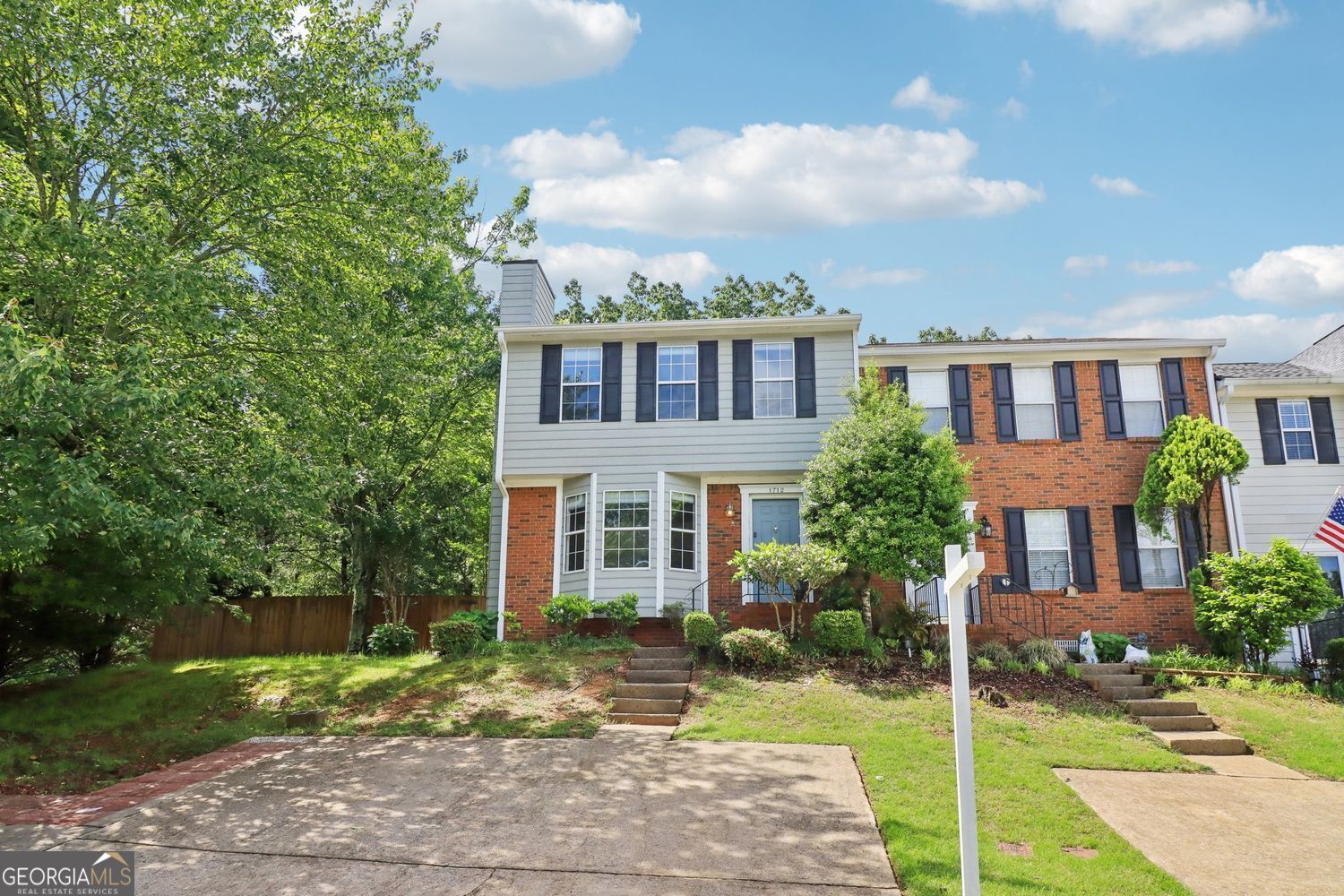 "Buyer will Receive a $3,500 Lender Credit with preferred lender JT Trial-Certainty Home Lending"!! Offering one of the largest fully fenced yards in the community, this beautifully updated 3 bed / 2.5 bath end-unit townhome in Barnes Mill Lake truly stands out-and it's located in the highly sought-after Wheeler School District! The home lives like a single-family residence, with a spacious back and side yard, plus 3 dedicated parking spaces (including 2 pads)-a rare bonus in the neighborhood. The backyard also includes a shed, perfect for additional storage. Inside, you'll love the luxury LVP flooring throughout, the generous living area filled with natural light, and the fully remodeled bathrooms featuring high-end quartz countertops. In the living room, you'll find a gorgeous updated fireplace with Taj Mahal quartzite, which beautifully matches the updated downstairs half bath countertop. The bright kitchen opens to an oversized back deck, ideal for entertaining or relaxing in your private outdoor space. Upstairs offers a spacious primary suite, two additional bedrooms, and a shared bath. The low HOA includes front yard maintenance, trash pickup, and grounds upkeep. Located just minutes from I-75, The Battery, Town Center, and downtown Marietta-this is a rare opportunity in a prime location. Don't miss out!