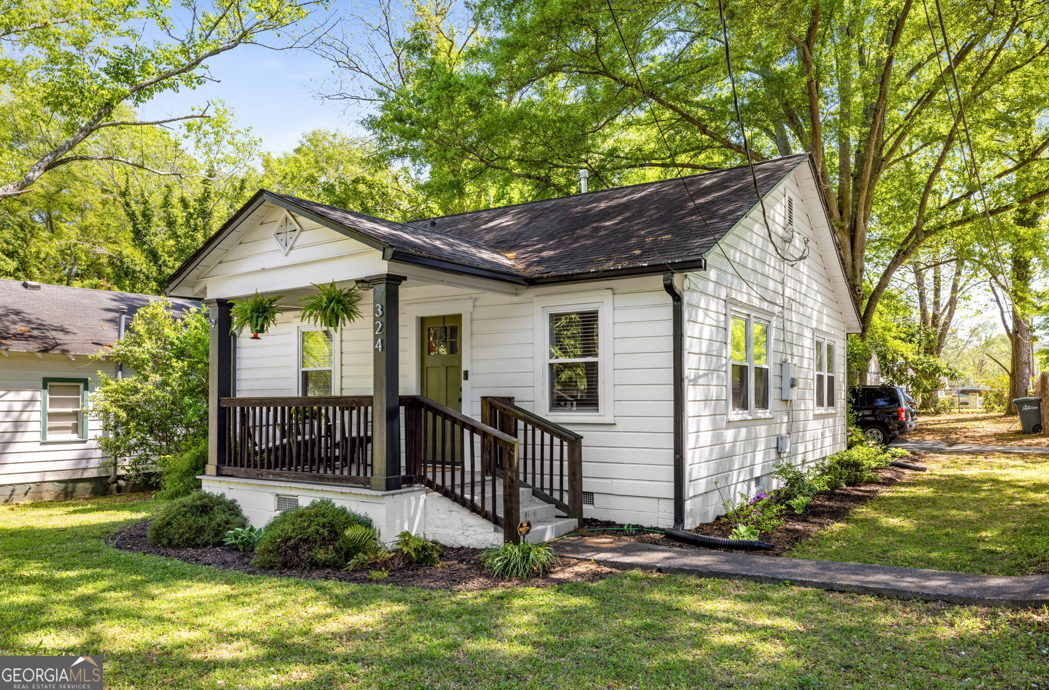Back on the Market due to buyer getting cold feet! Overflowing with cozy character, this 2-bedroom, 1-bath cottage captures the timeless charm of historic Marietta living. Just a short walk to the vibrant Marietta Square, this inviting home blends vintage appeal with everyday comfort. Inside, you'll find original hardwood floors, exposed wood beams, and beautiful wood-slatted ceilings that add warmth and personality to every room. A charming electric fireplace anchors the living area, creating the perfect spot to unwind. Step outside to a screened-in back porch - ideal for slow mornings or relaxed evenings - and an entertainer's backyard perfect for gatherings under the stars. A storage shed offers extra space for tools, hobbies, or seasonal decor. If you're seeking a cozy, character-filled home with unbeatable walkability, this is it. Enjoy life just steps from Marietta's best dining, shops, and year-round events - and come home to a place that feels like a true cottage retreat.